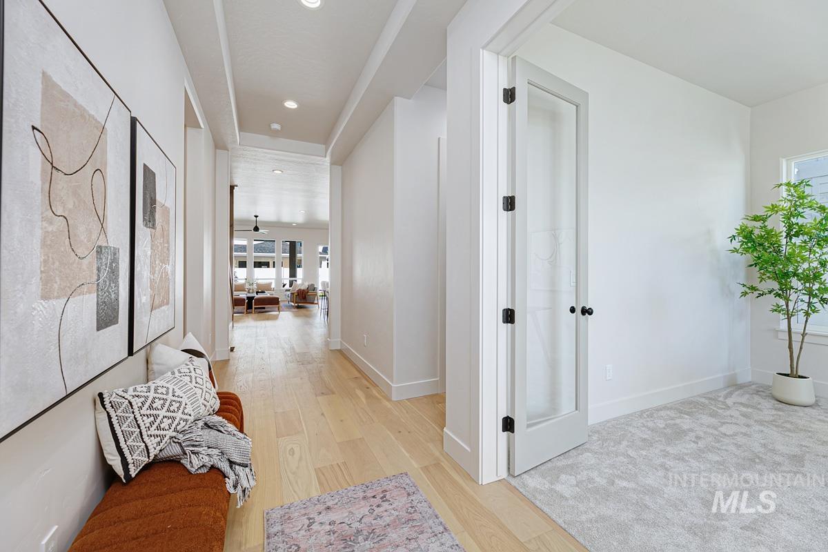 Corridor featuring light wood finished floors and recessed lighting