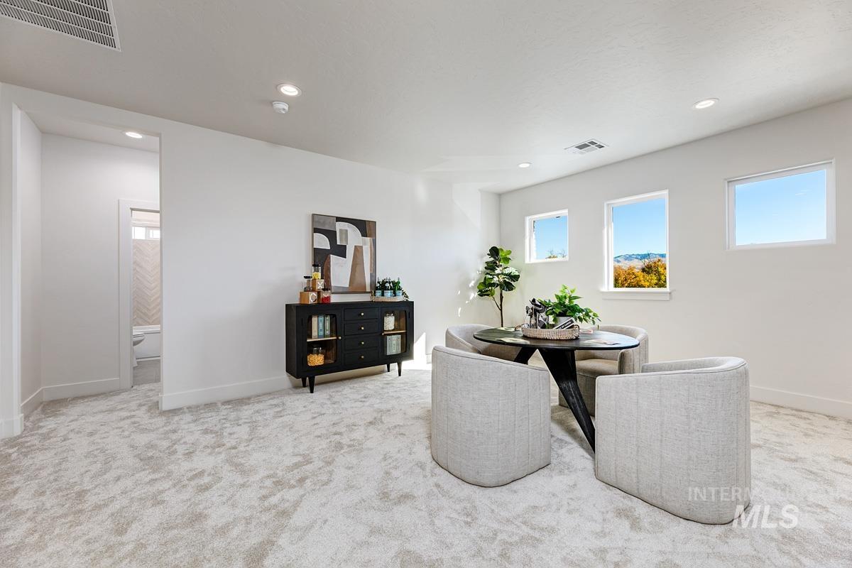 Dining area featuring light carpet and recessed lighting