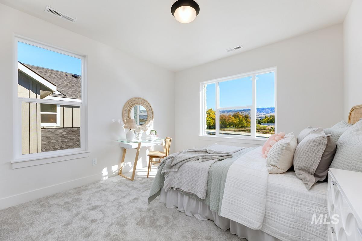 Bedroom featuring carpet flooring and baseboards