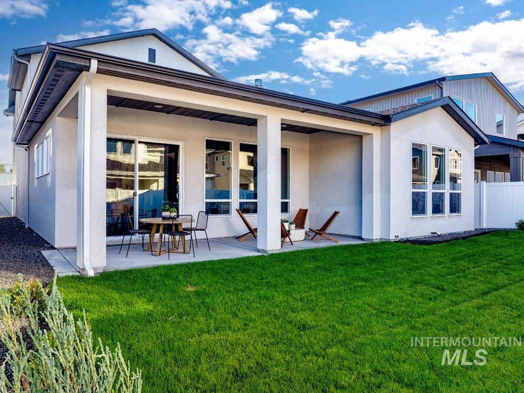 Back of house with a patio and stucco siding