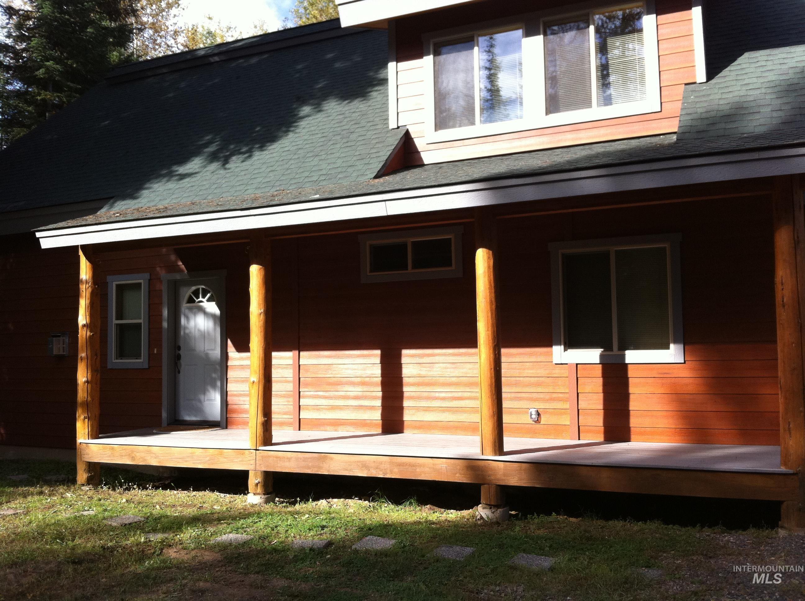 View of side of property featuring a shingled roof