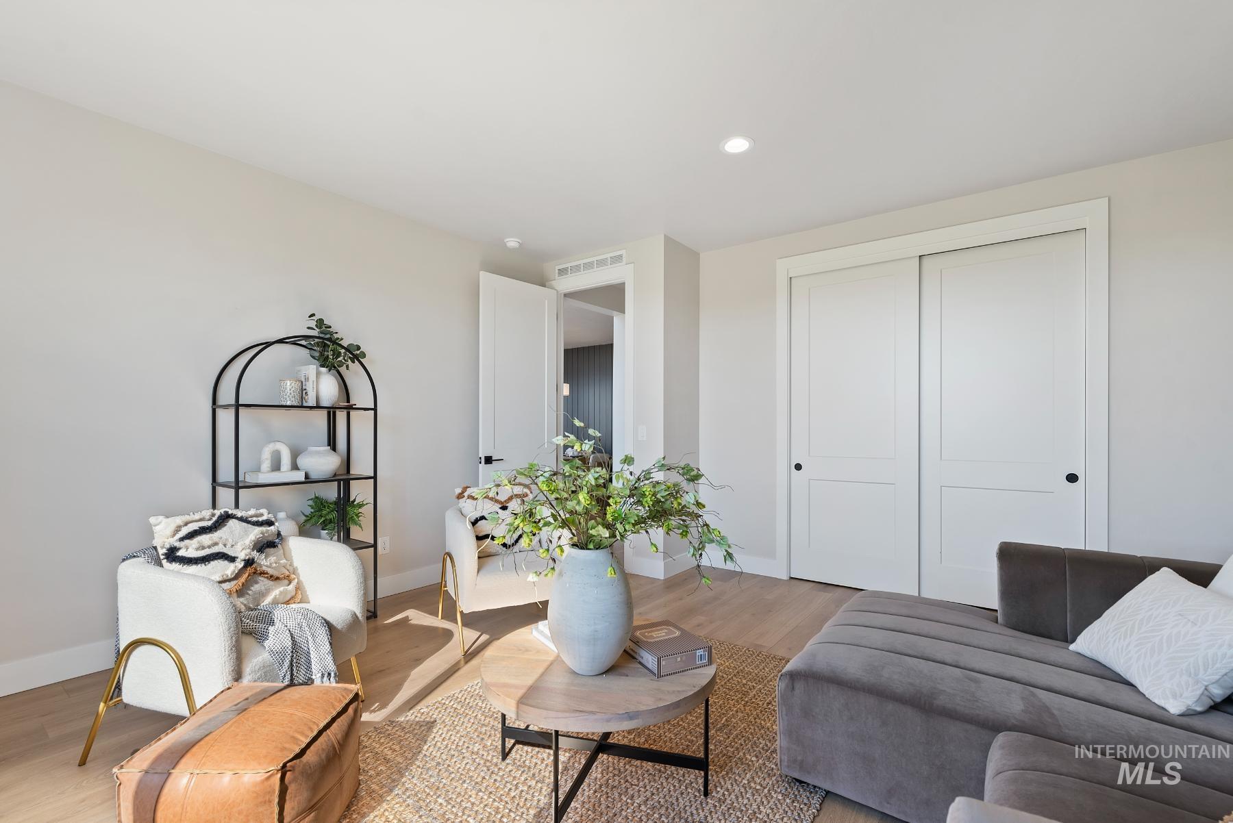 Living room with wood finished floors and recessed lighting