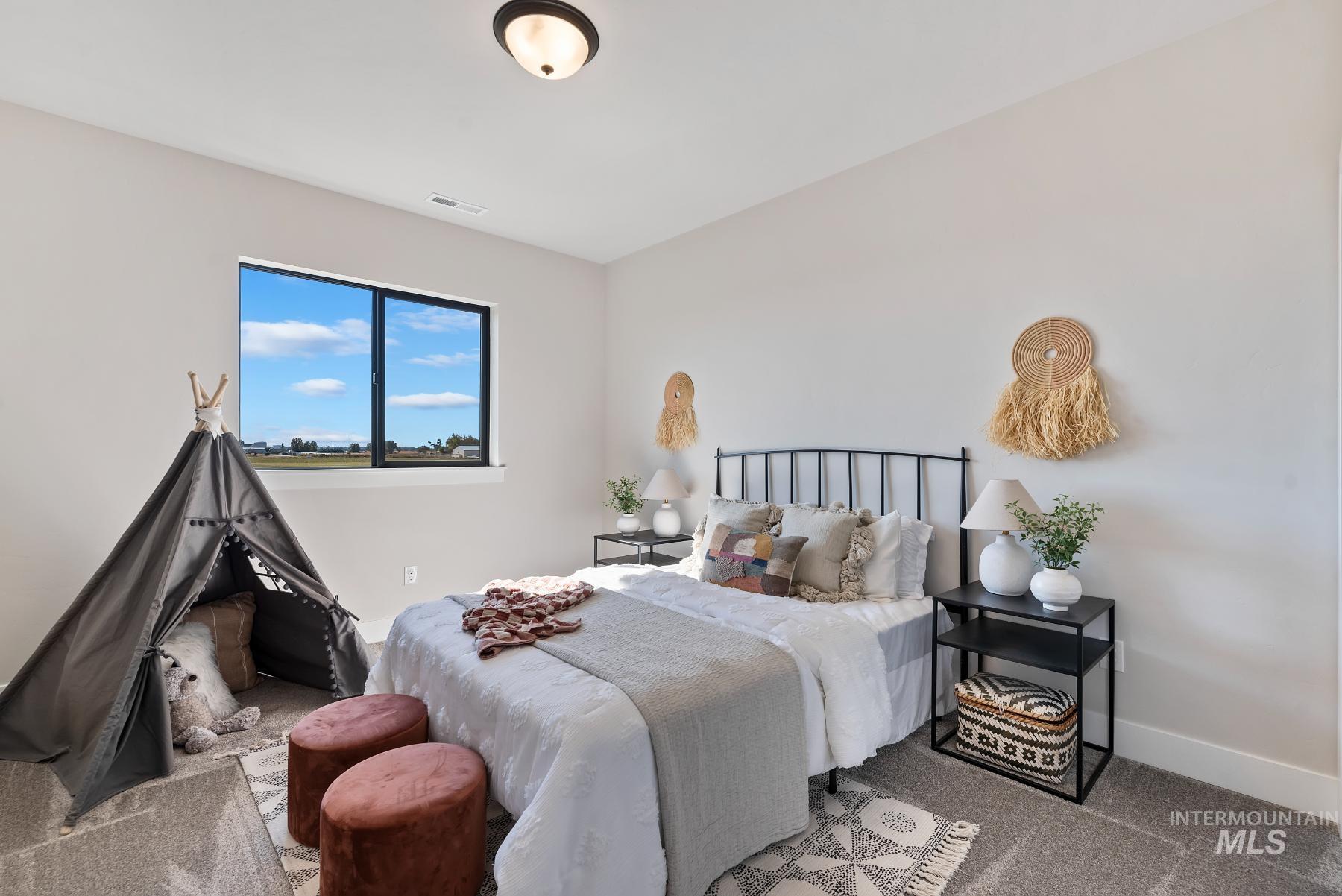Bedroom featuring carpet and baseboards