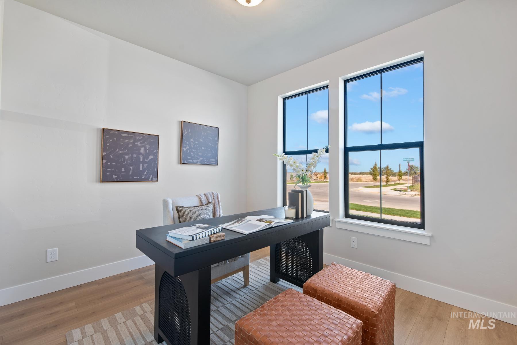 Home office featuring baseboards and light wood-type flooring