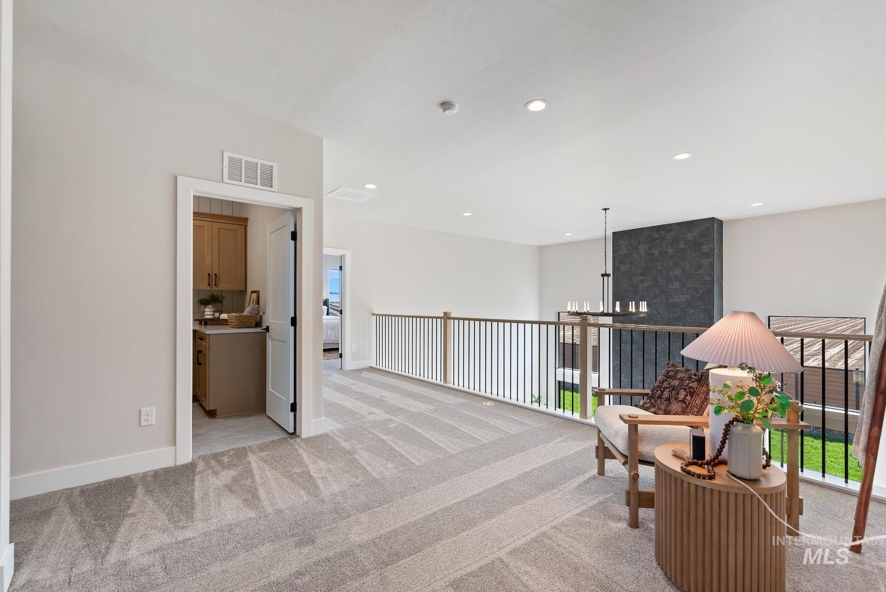 Living area featuring light carpet, recessed lighting, a chandelier, and healthy amount of natural light