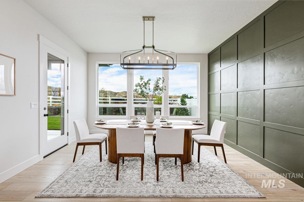 Dining space featuring light wood-style flooring and a chandelier