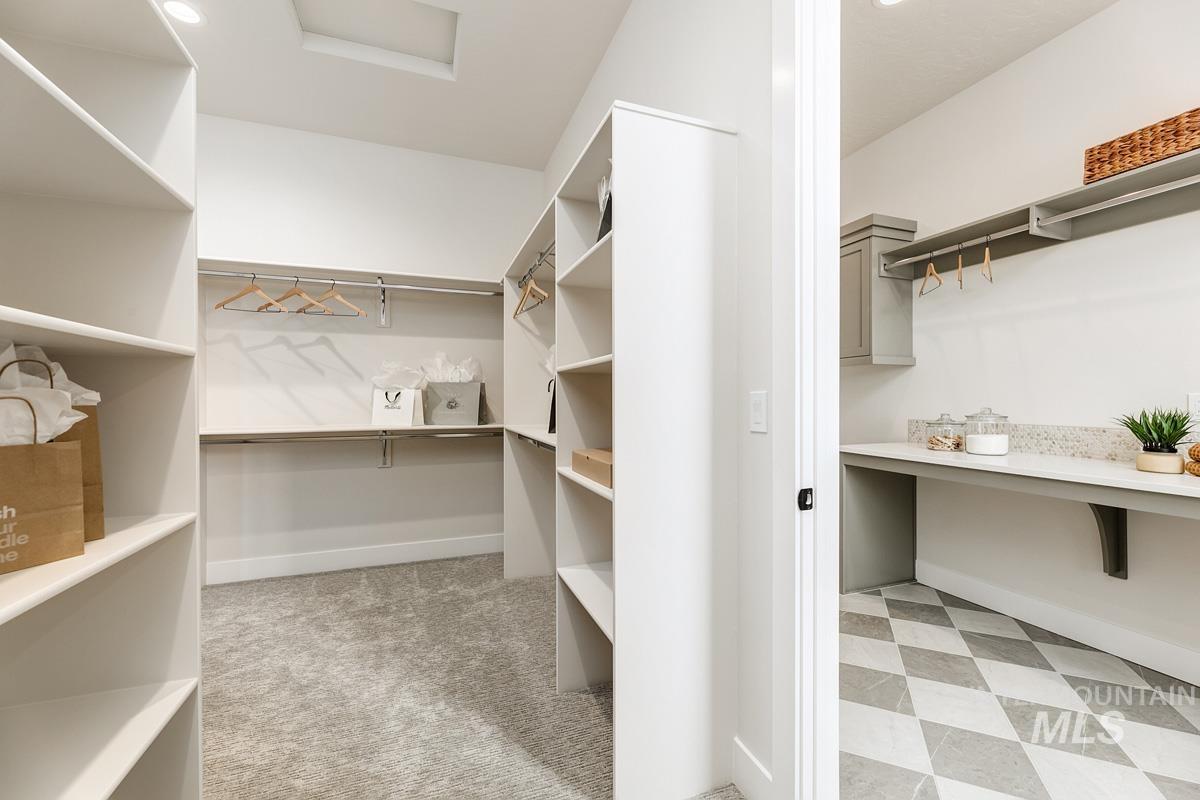 Walk in closet with light floors