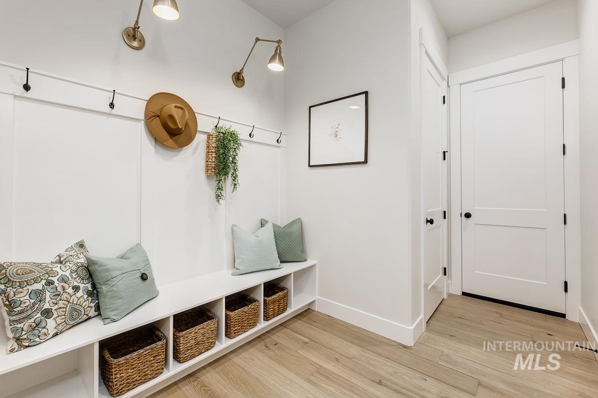 Mudroom featuring baseboards and light wood-style flooring