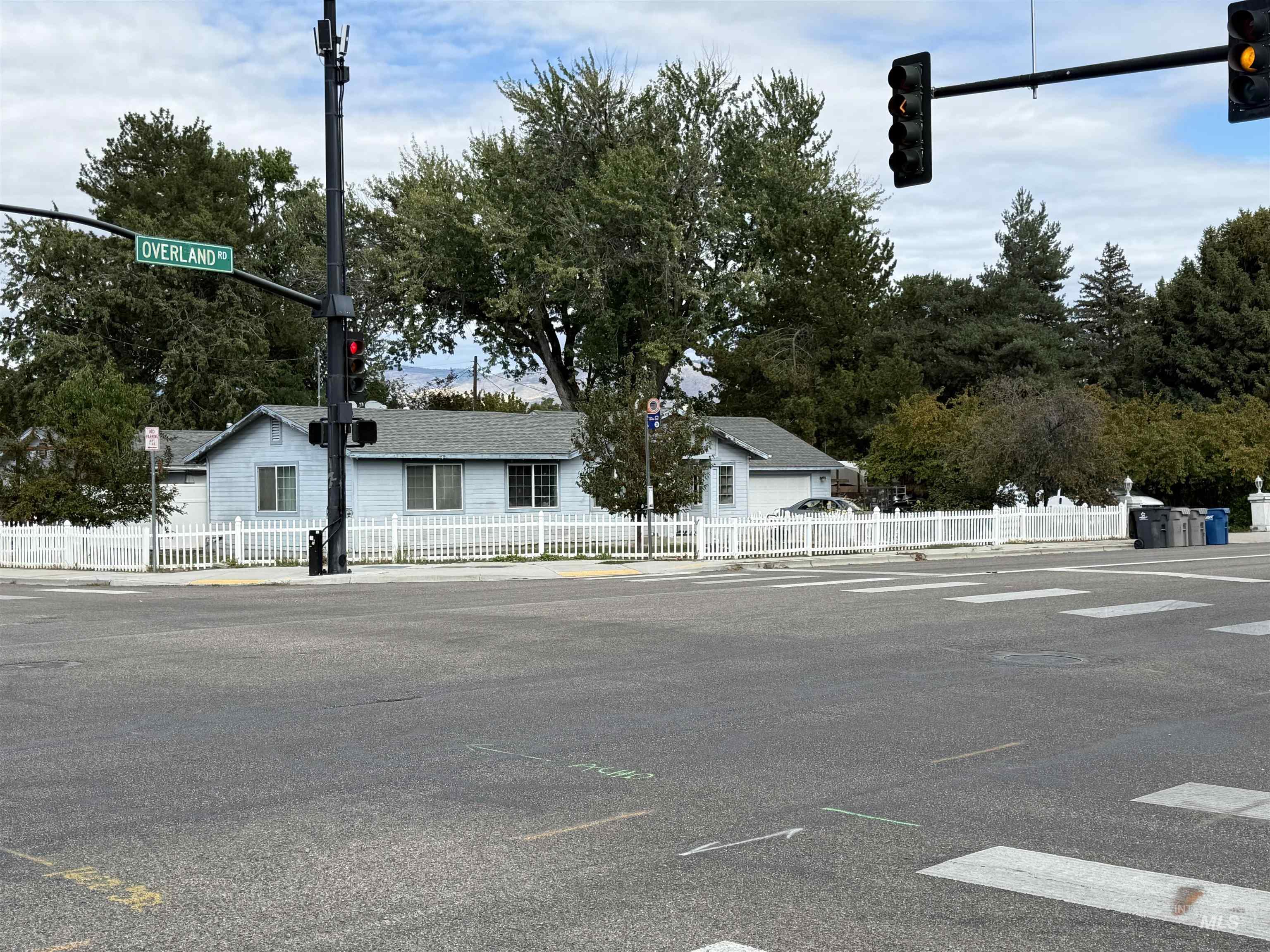 View of front of property with a fenced front yard and uncovered parking