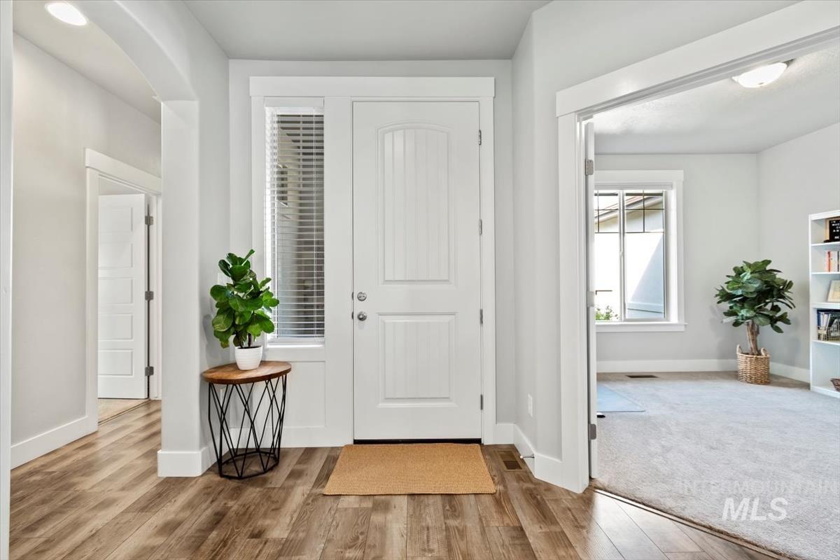Entryway featuring baseboards and wood finished floors