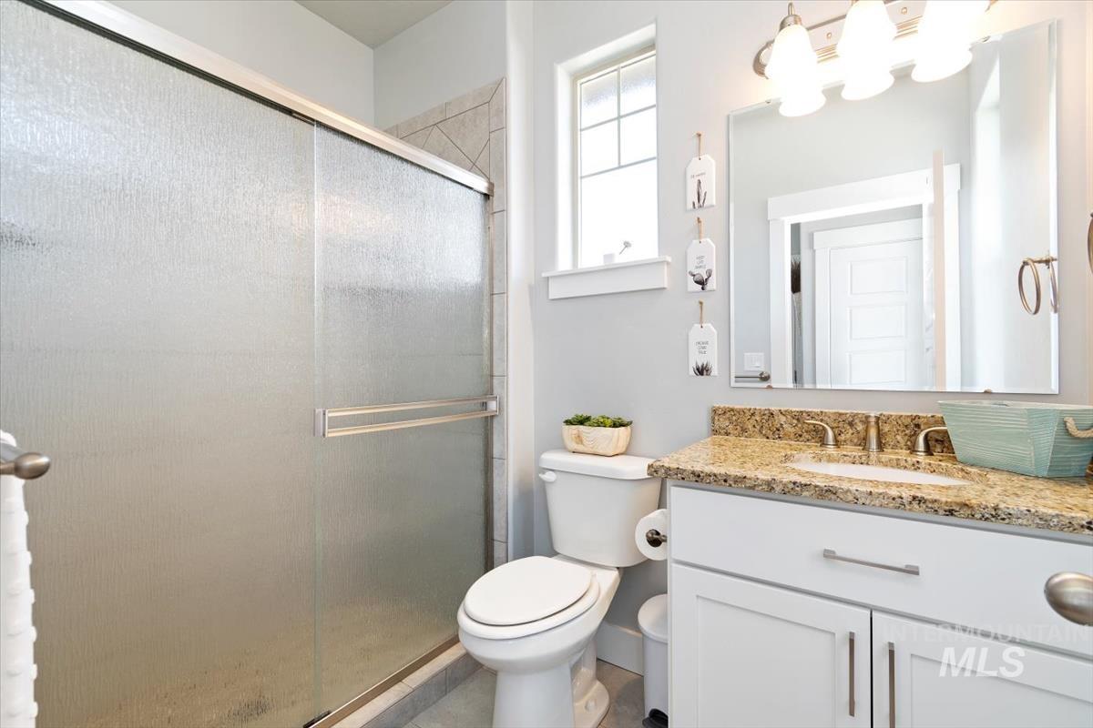 Full bathroom with a shower stall and vanity
