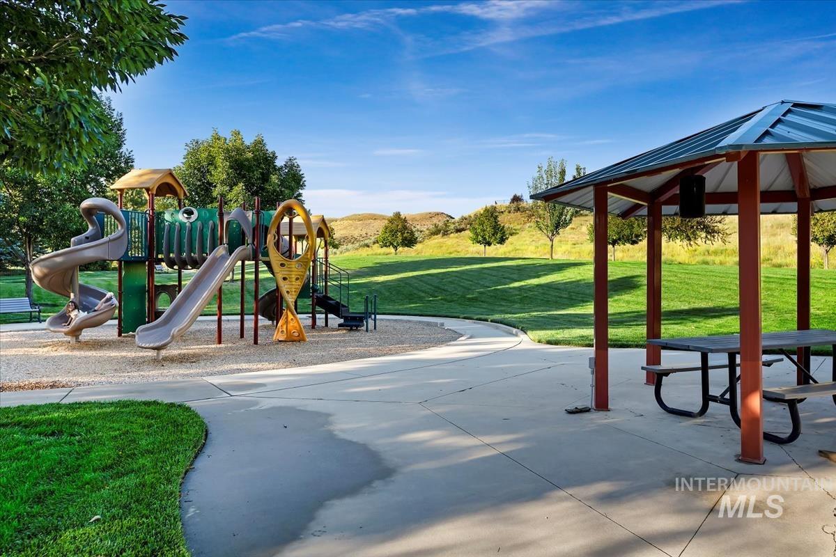 Community jungle gym with a yard, a gazebo, and a patio area