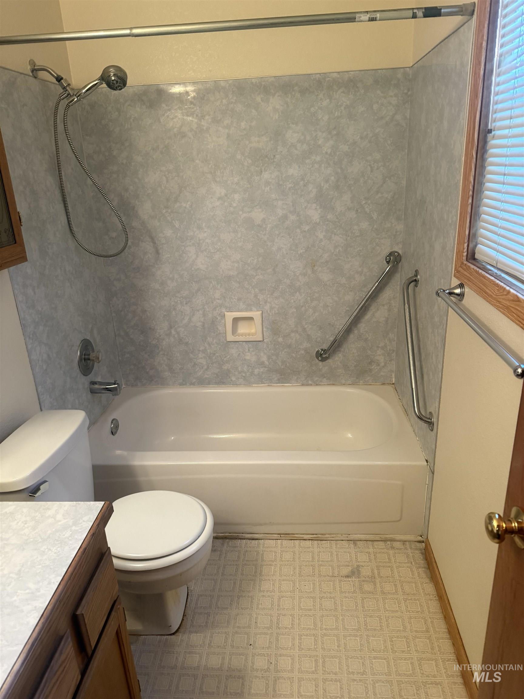 Full bath featuring shower / bathtub combination, vanity, and light flooring