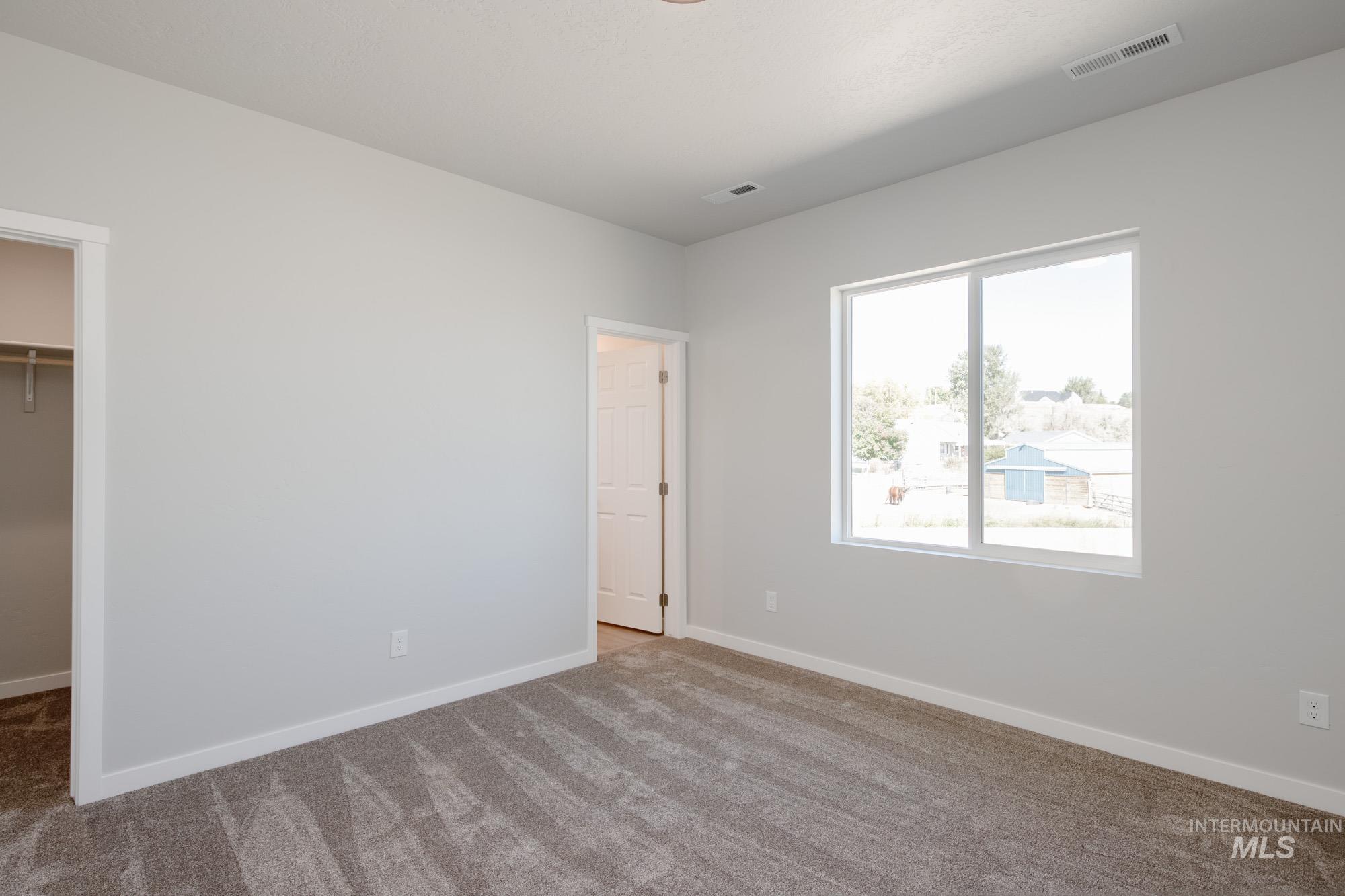 Unfurnished bedroom featuring a spacious closet and carpet flooring