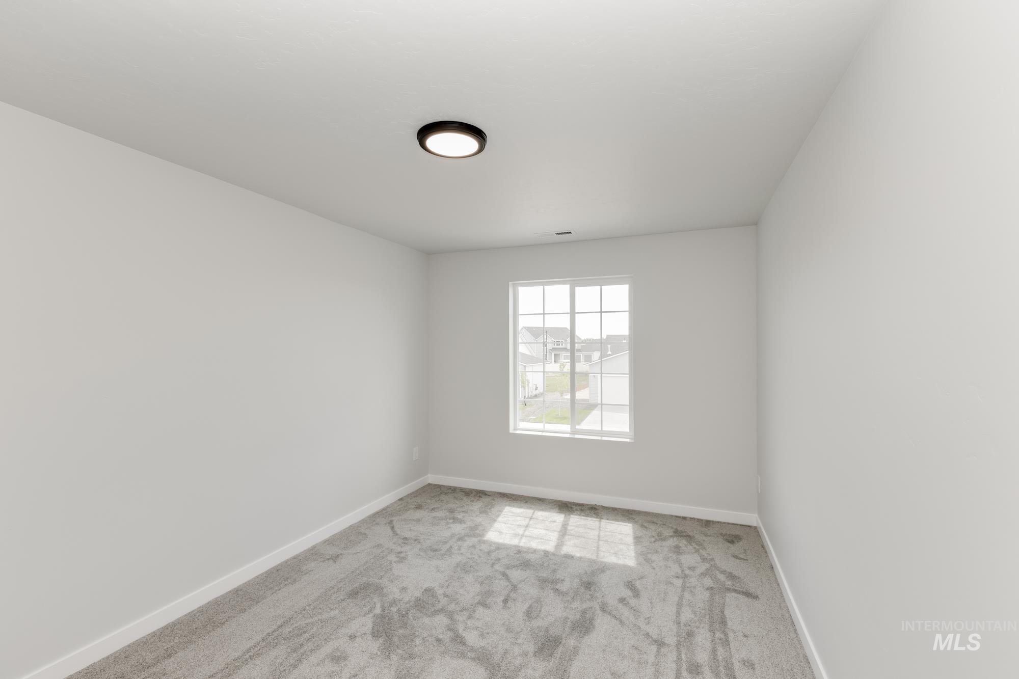 Spare room featuring light colored carpet