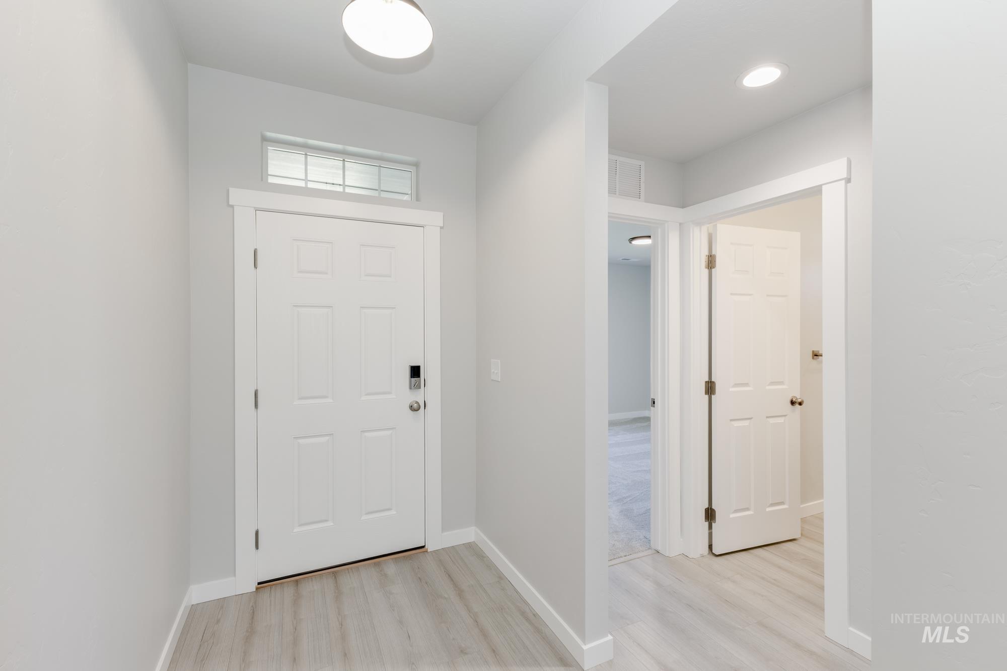 Foyer featuring light wood-type flooring and recessed lighting