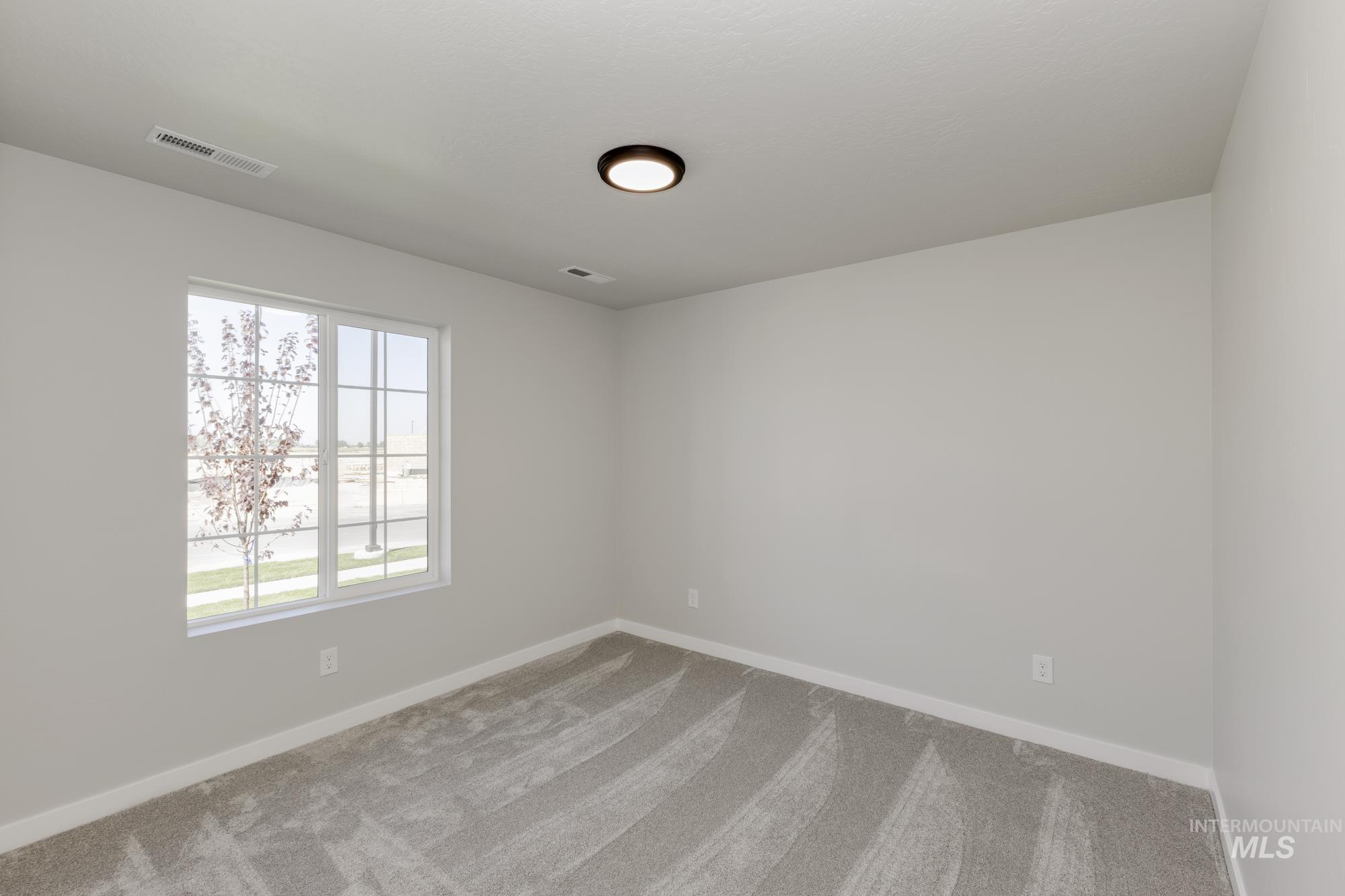 Spare room with carpet flooring and baseboards
