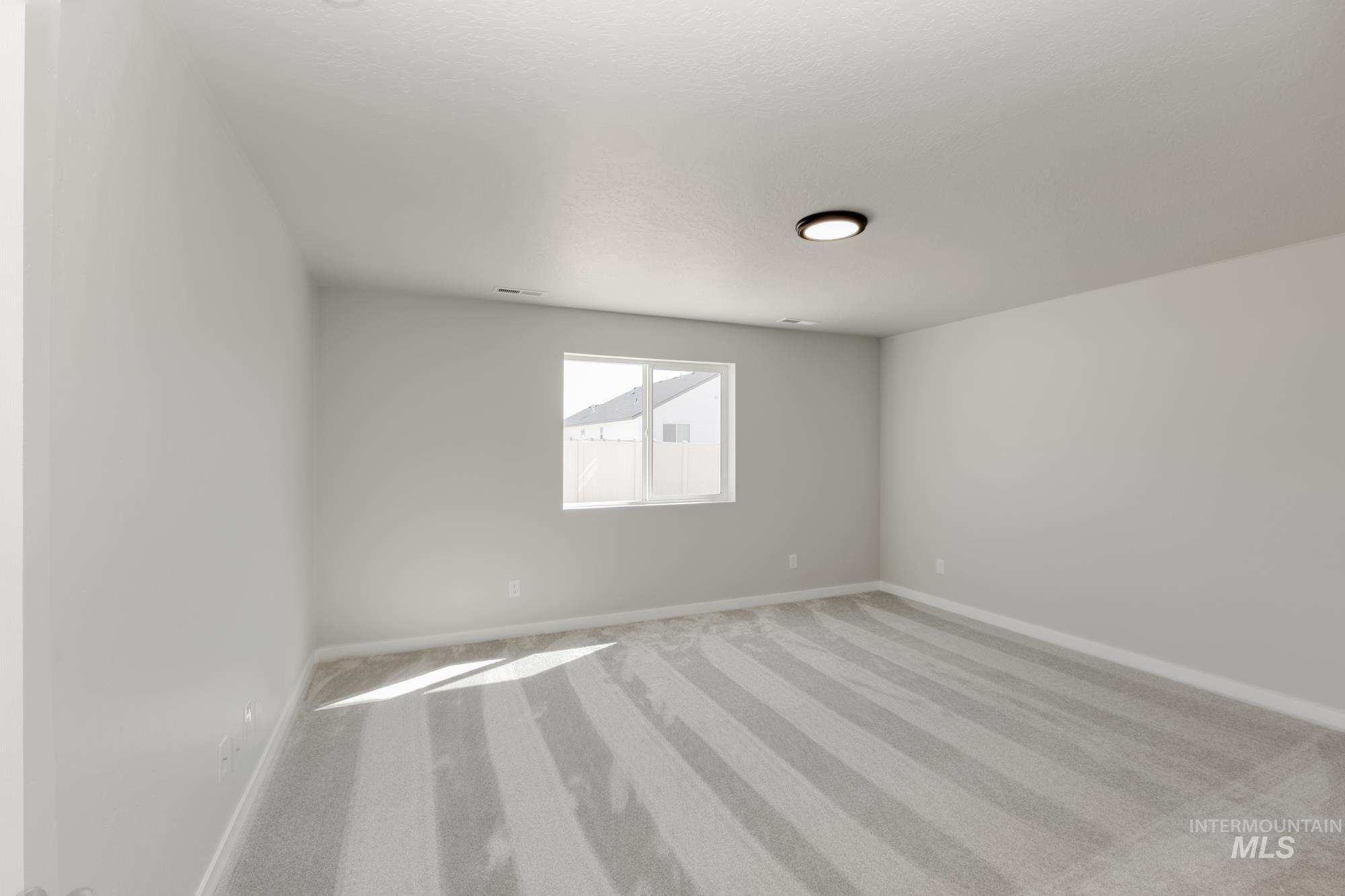 Empty room featuring carpet floors and baseboards