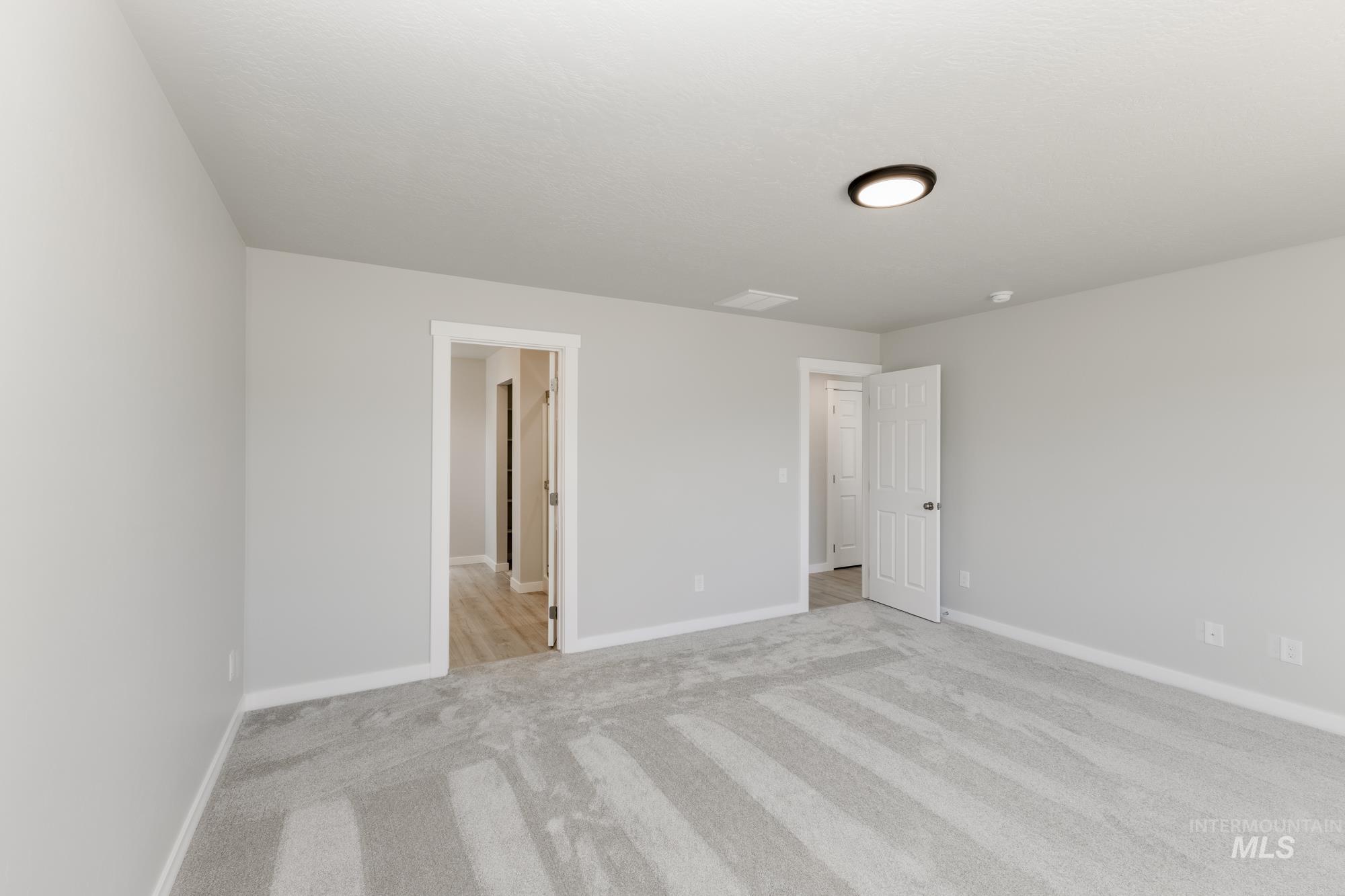 Unfurnished bedroom featuring carpet and baseboards