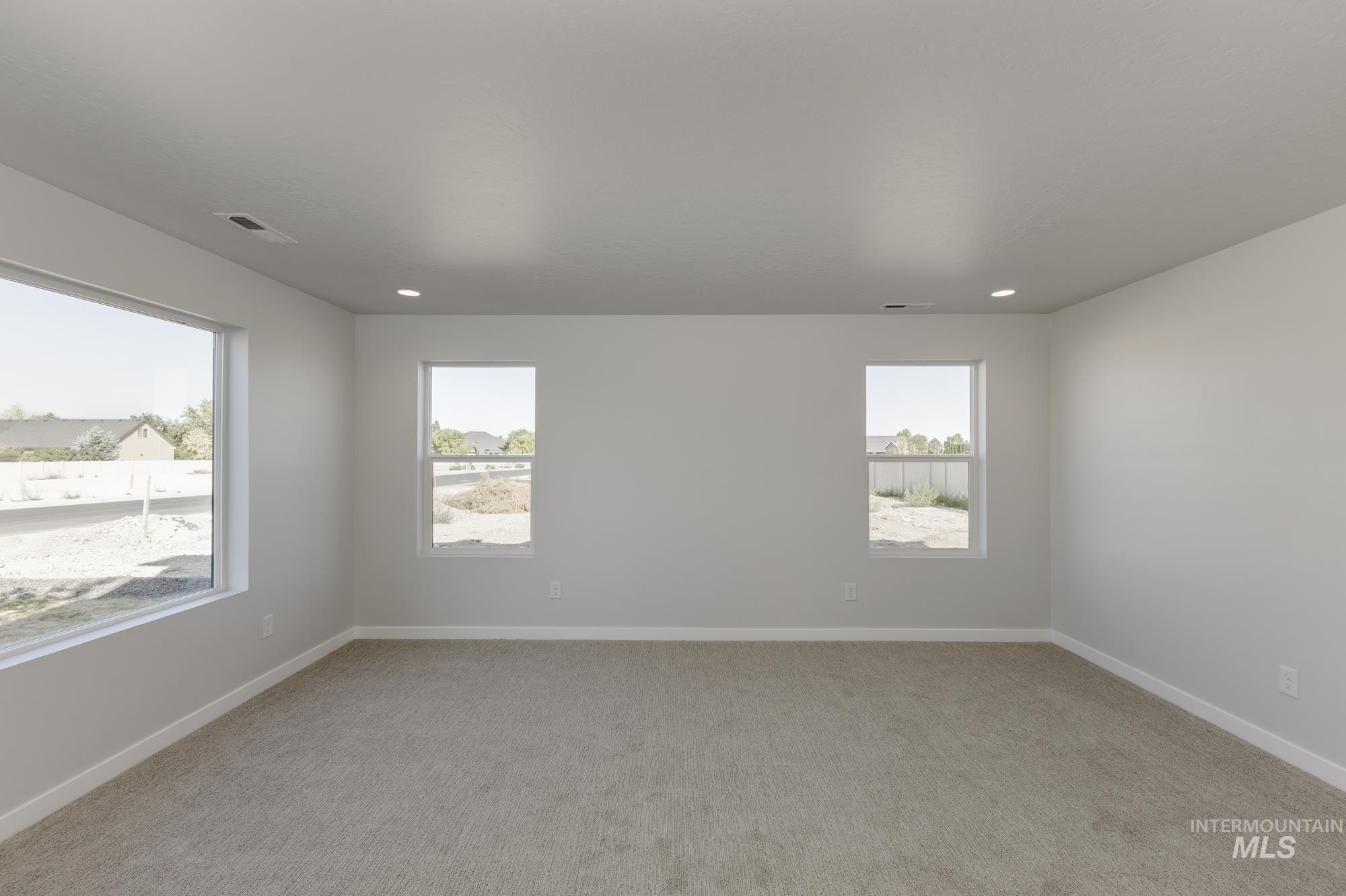 Unfurnished room with light carpet and recessed lighting