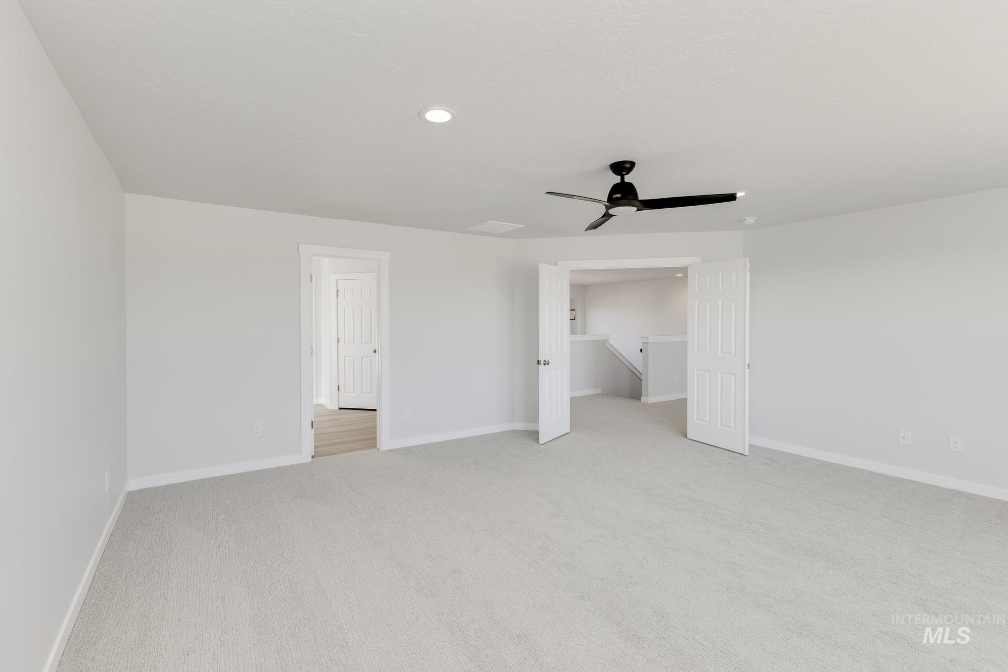 Unfurnished bedroom with light carpet, recessed lighting, and ceiling fan
