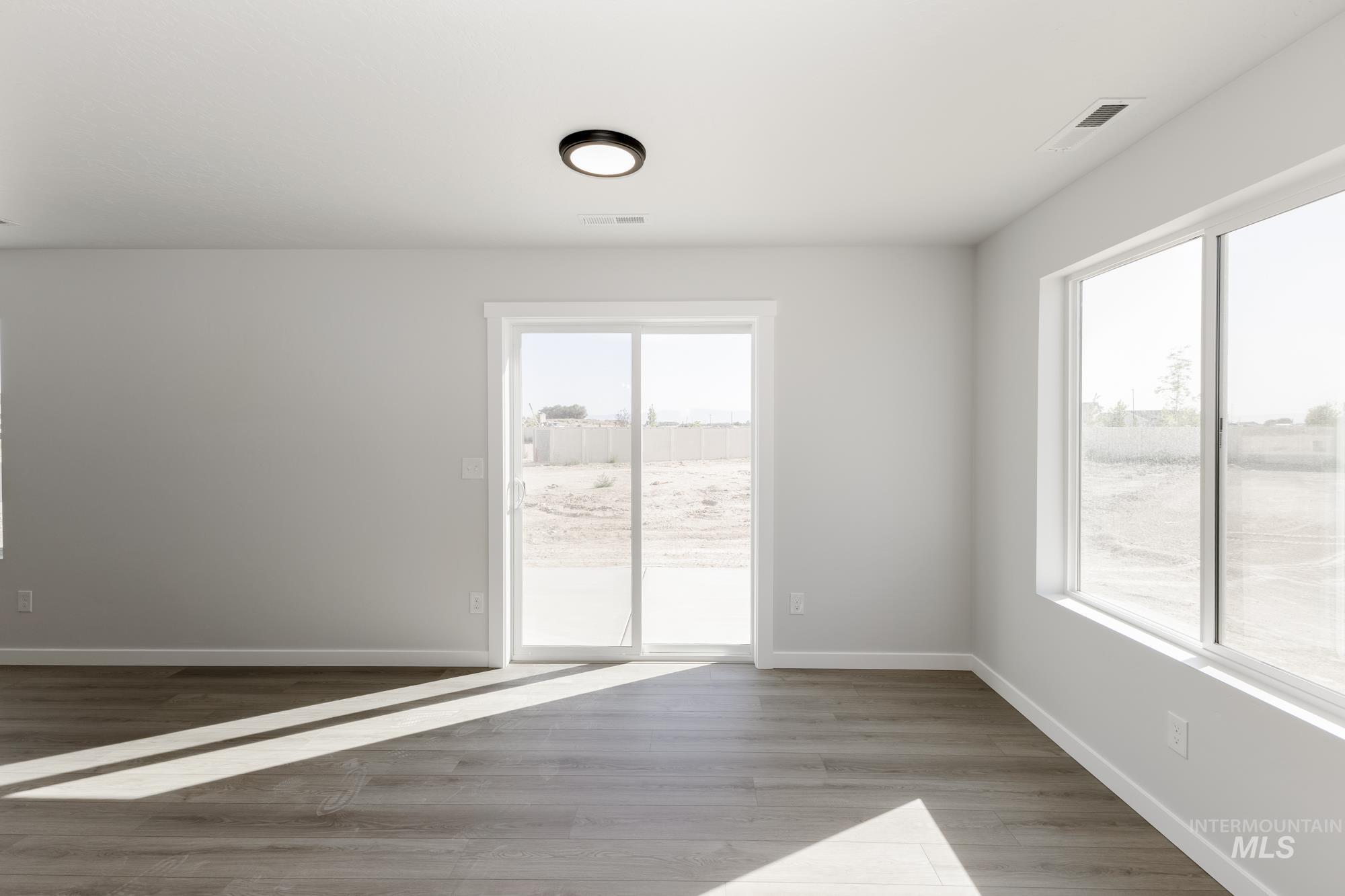 Unfurnished room featuring baseboards and light wood finished floors