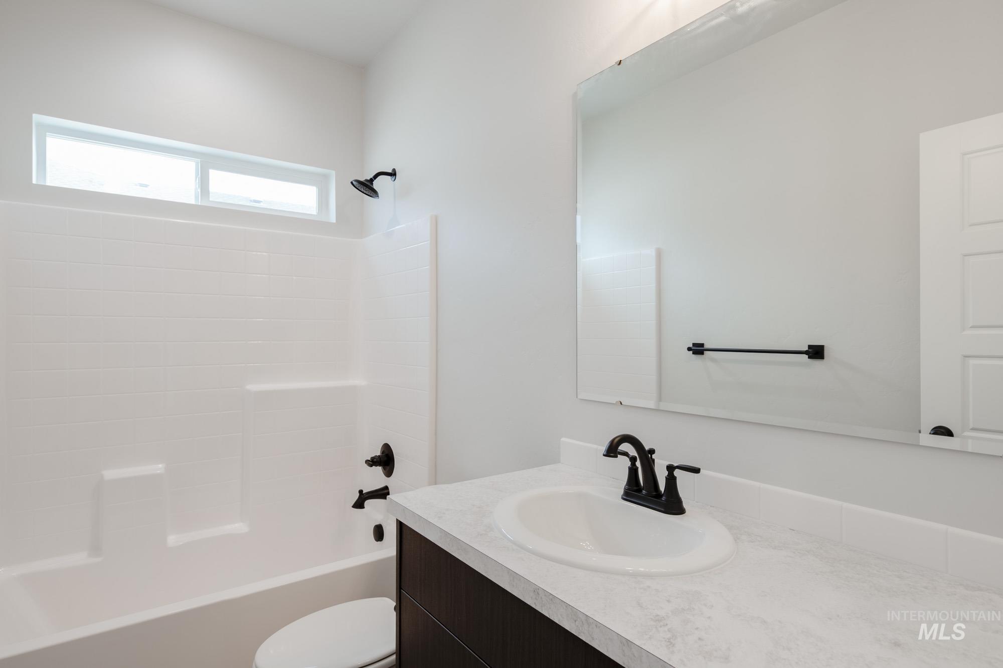 Bathroom featuring shower / washtub combination and vanity