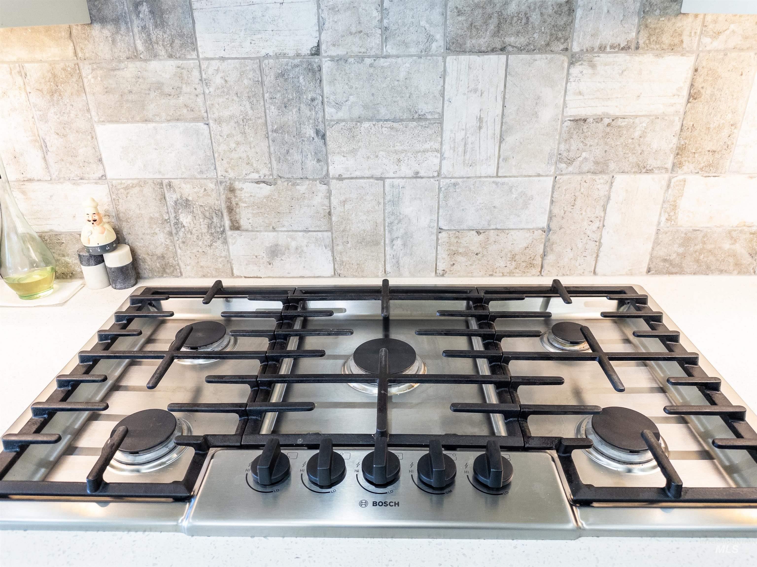 Kitchen view of stainless steel gas cooktop