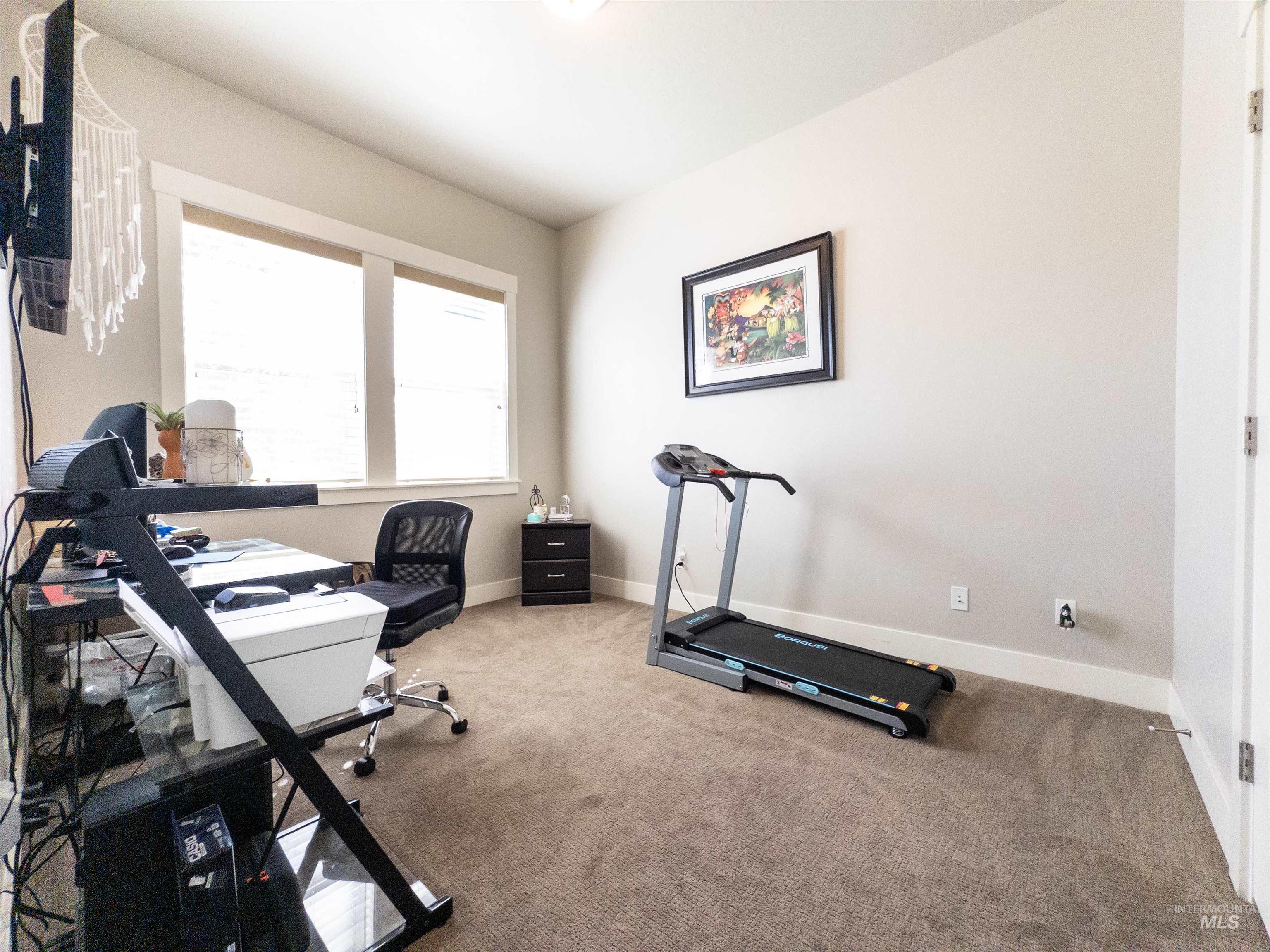 Office space featuring carpet floors and baseboards
