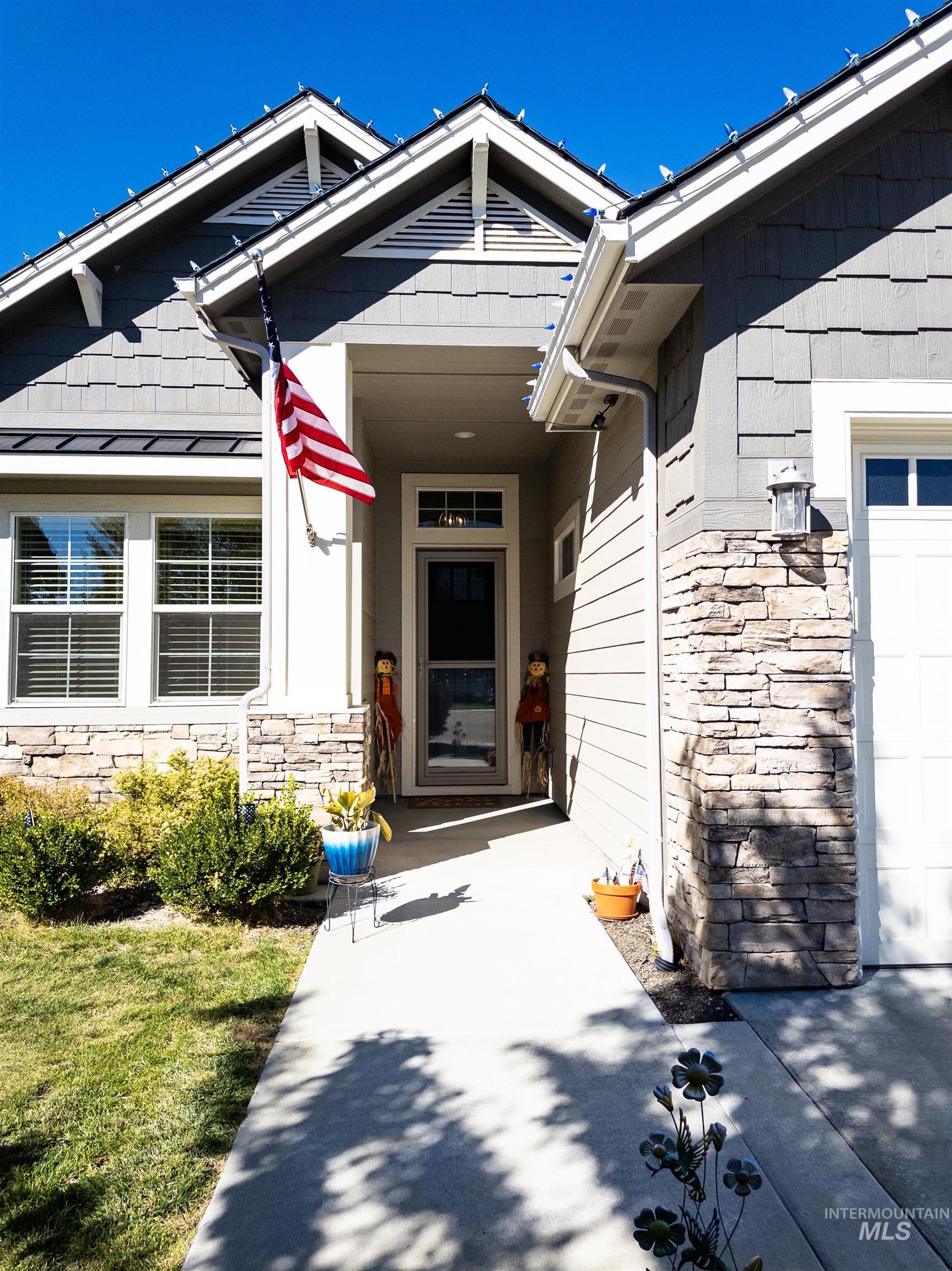 View of exterior entry with stone siding
