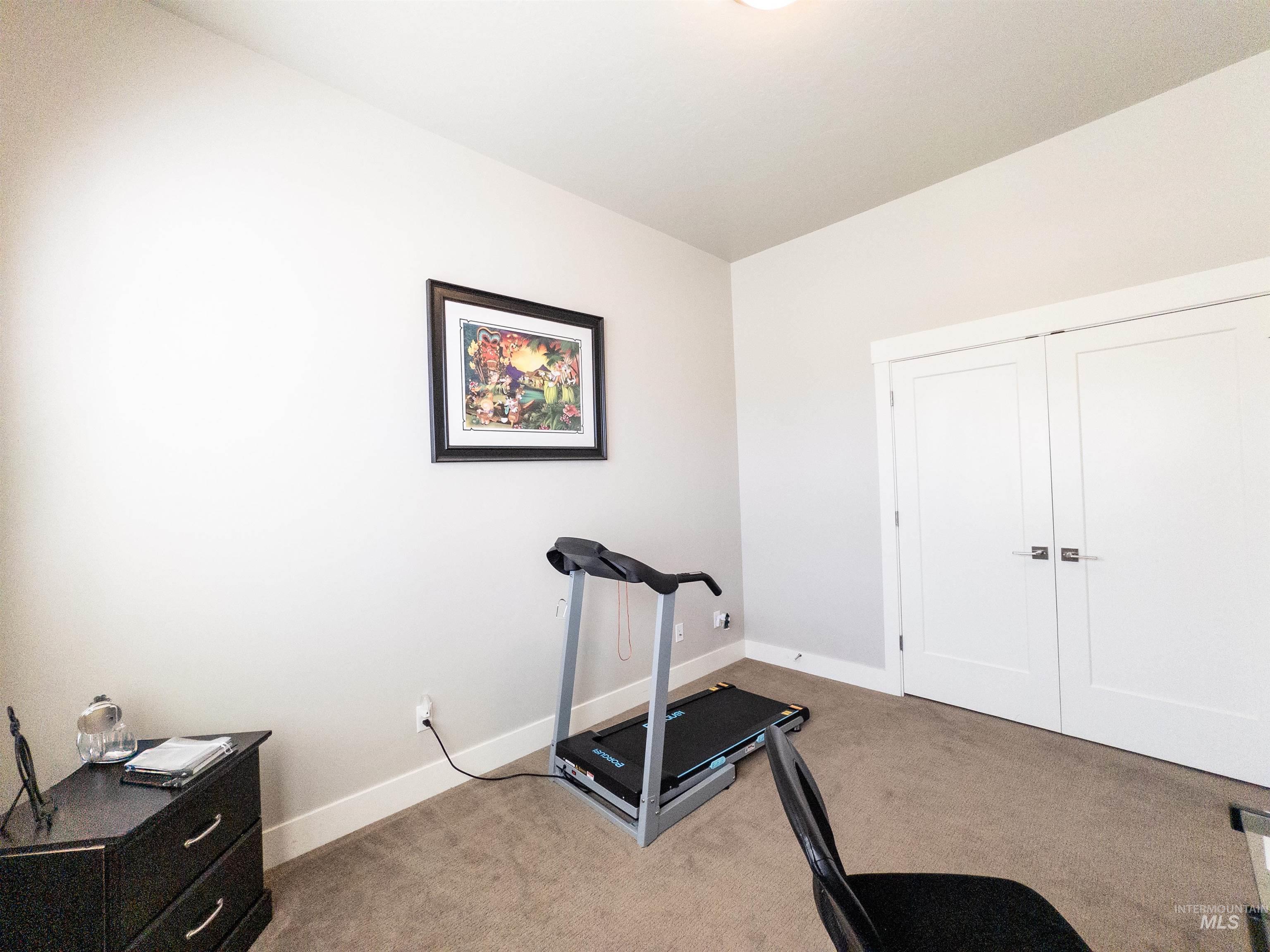Exercise room featuring light colored carpet