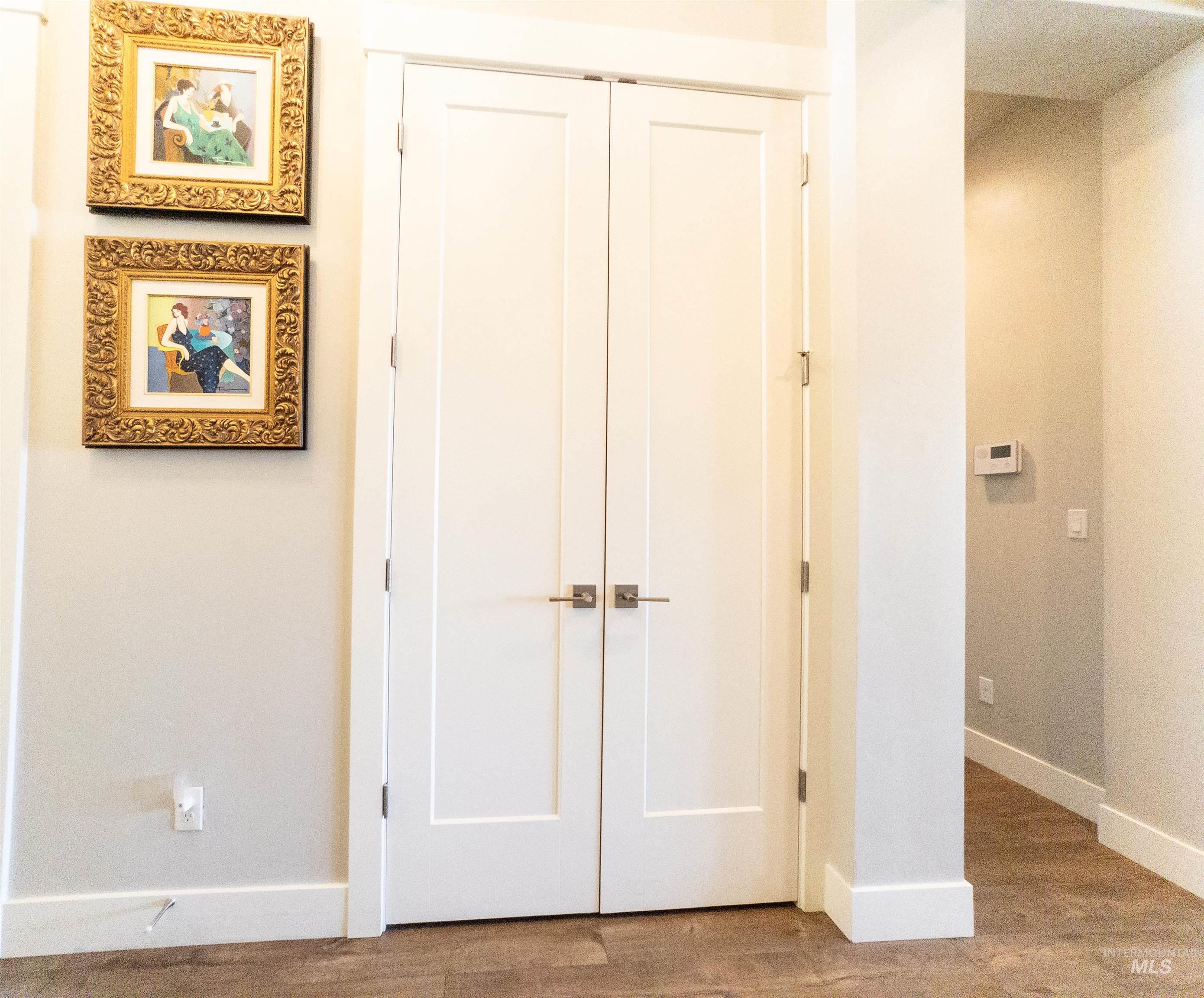 Hallway with baseboards and wood finished floors