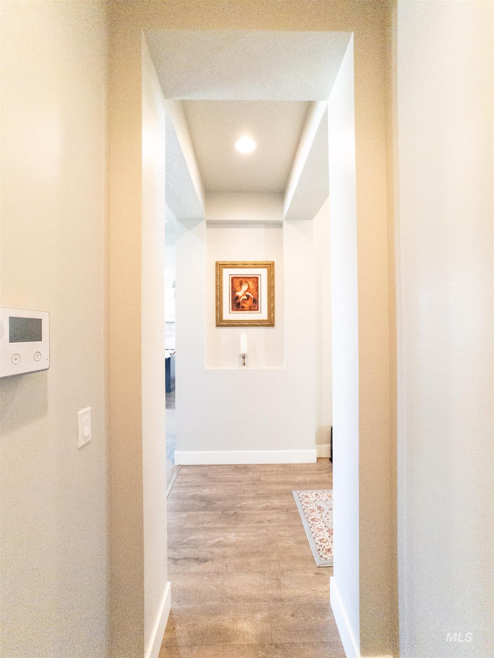 Corridor featuring light wood finished floors and recessed lighting