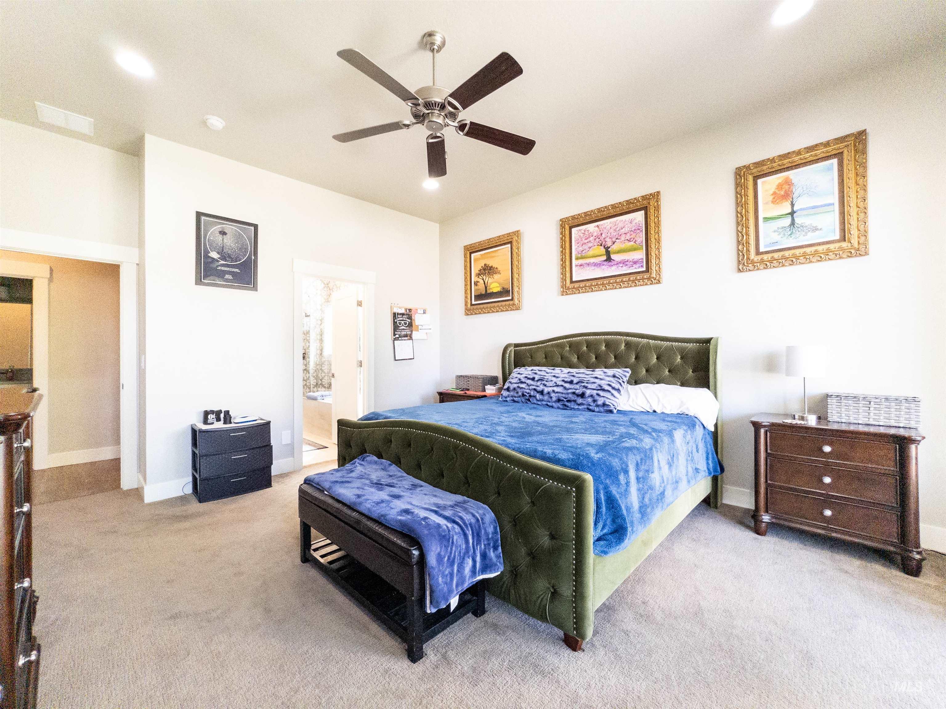 Bedroom featuring light carpet, a ceiling fan, recessed lighting, and ensuite bathroom