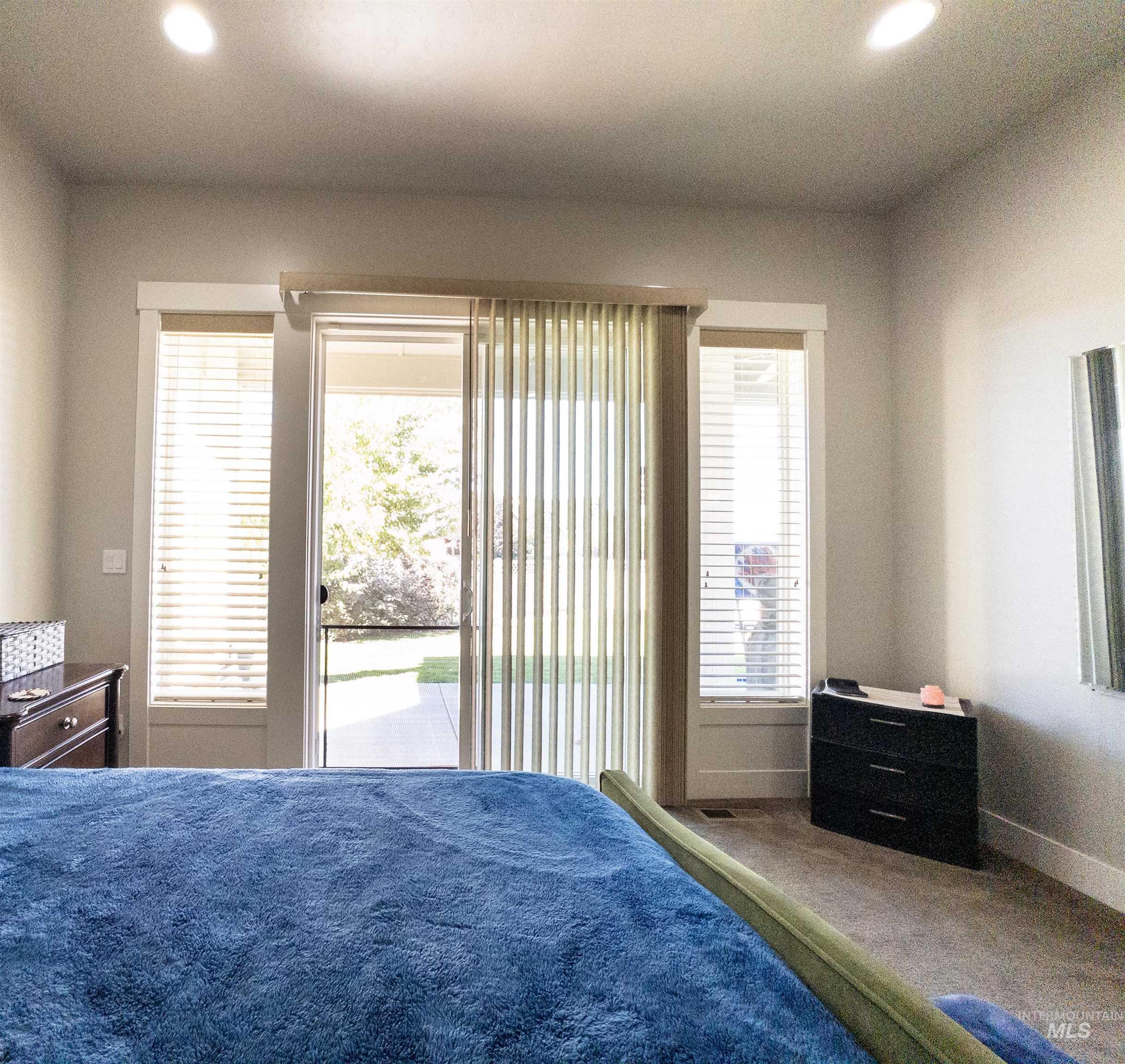 Bedroom featuring recessed lighting, access to exterior, and carpet