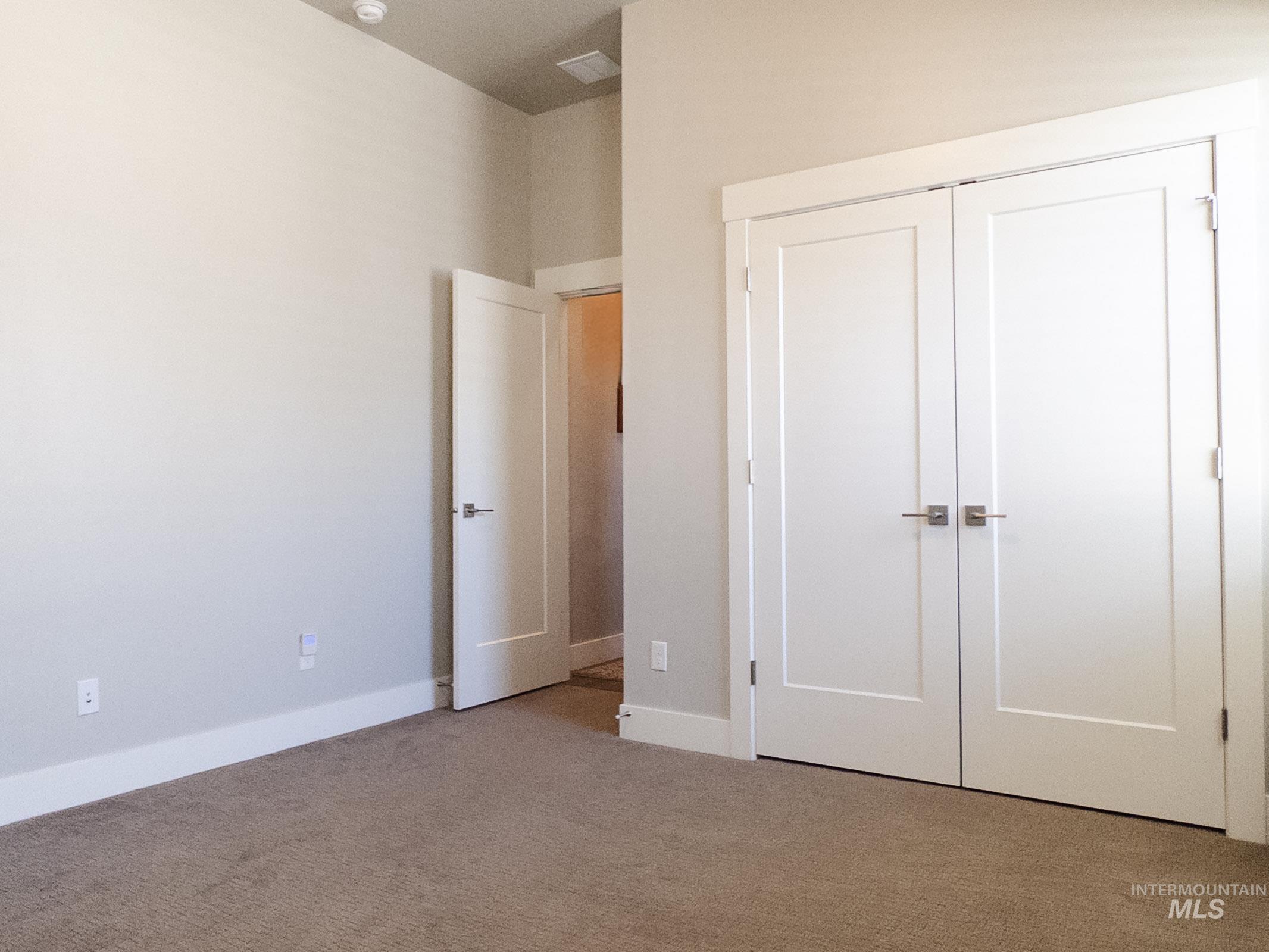 Unfurnished bedroom featuring a closet and carpet