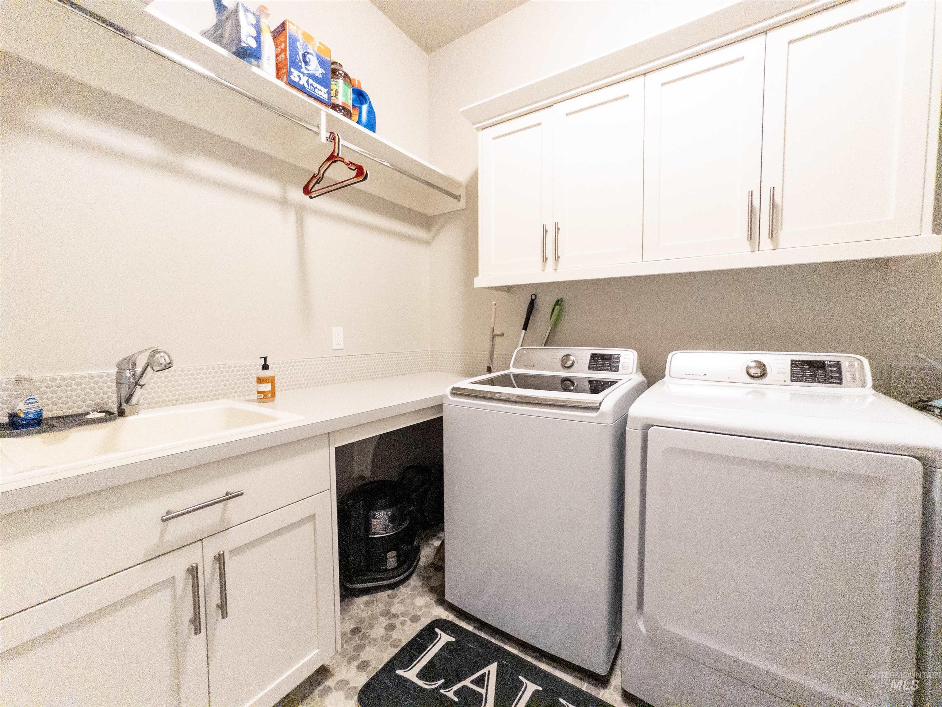 Laundry area featuring cabinet space and washer and clothes dryer