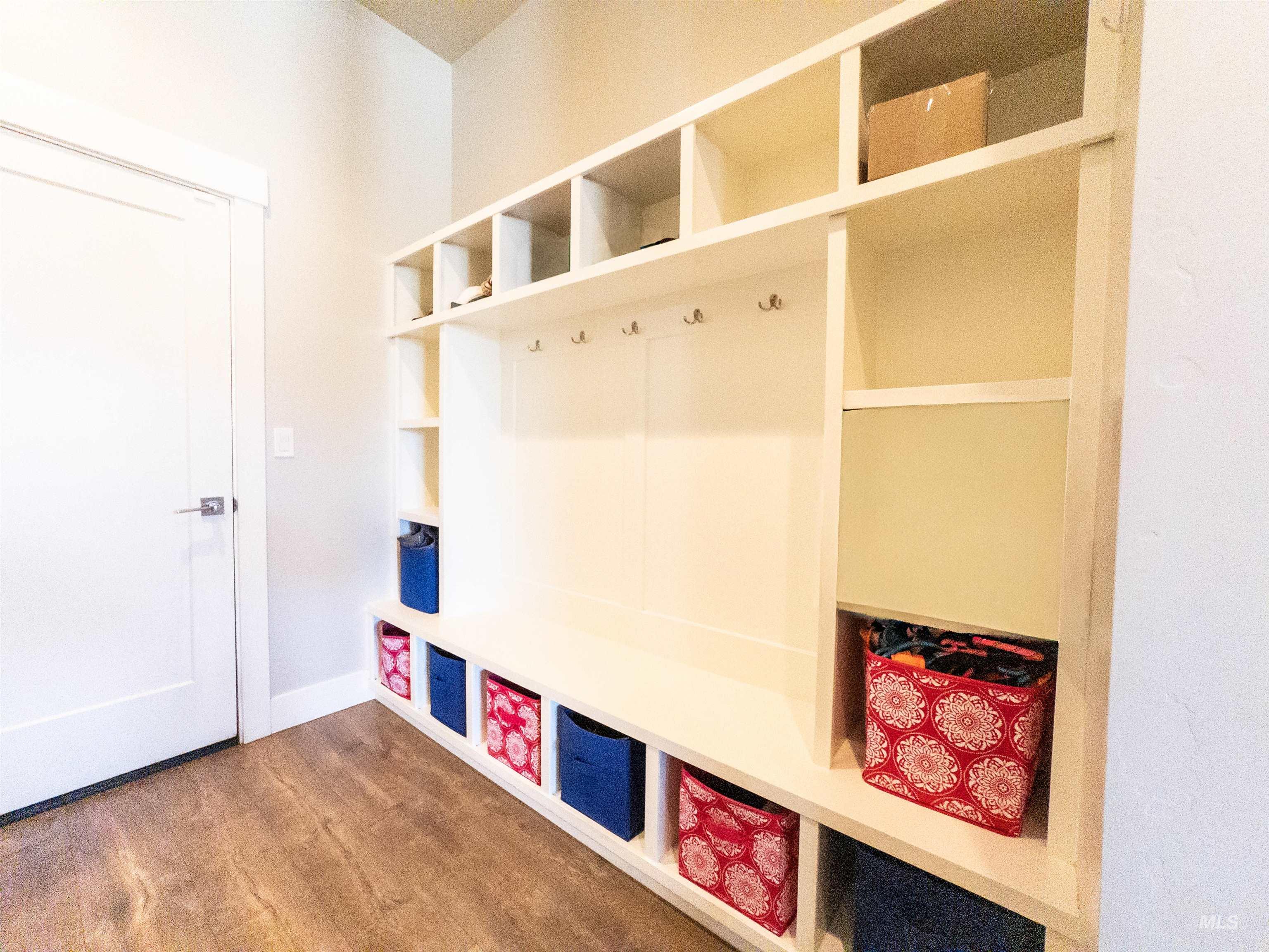 Mudroom with wood finished floors and baseboards