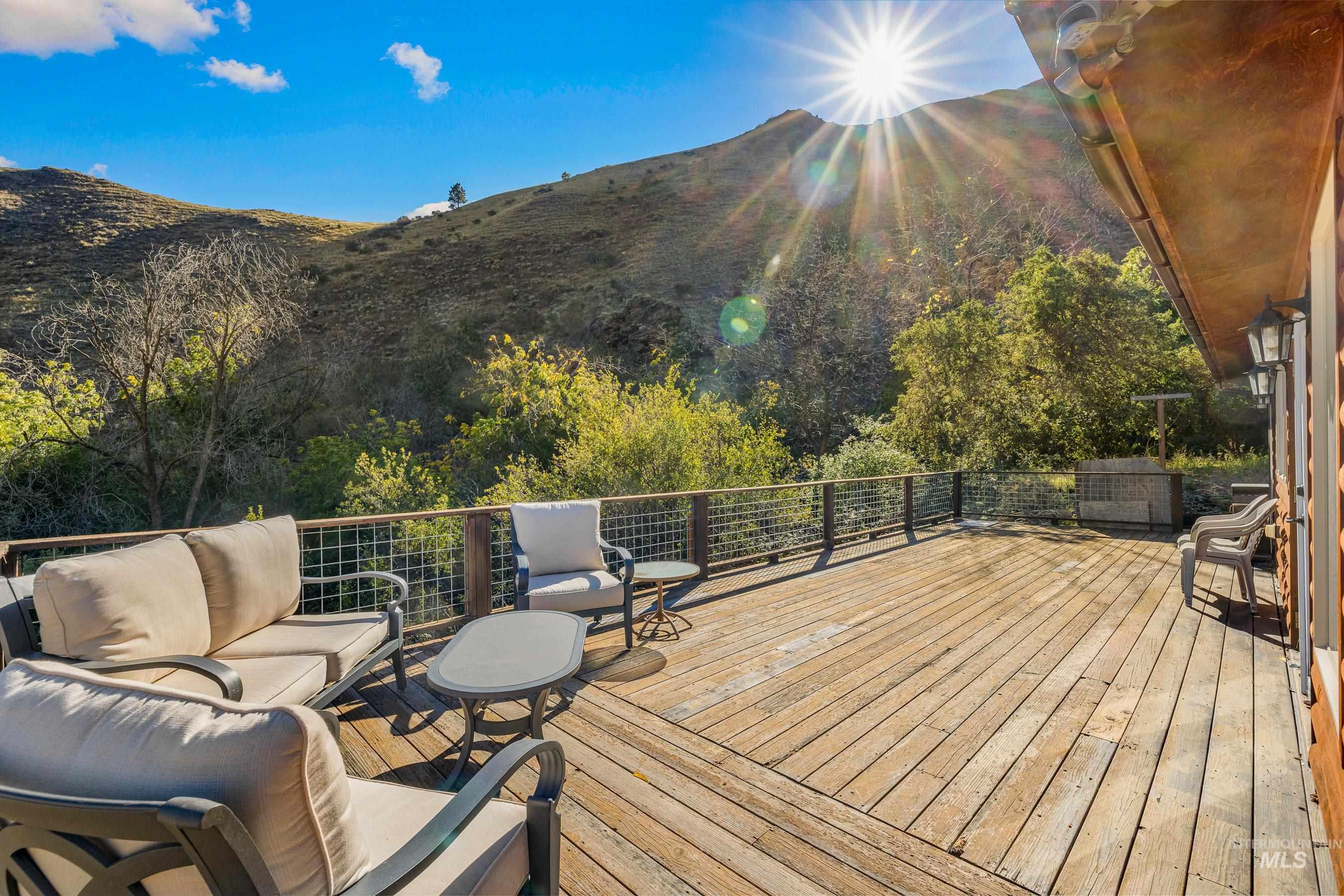 Deck with outdoor lounge area and a mountain view