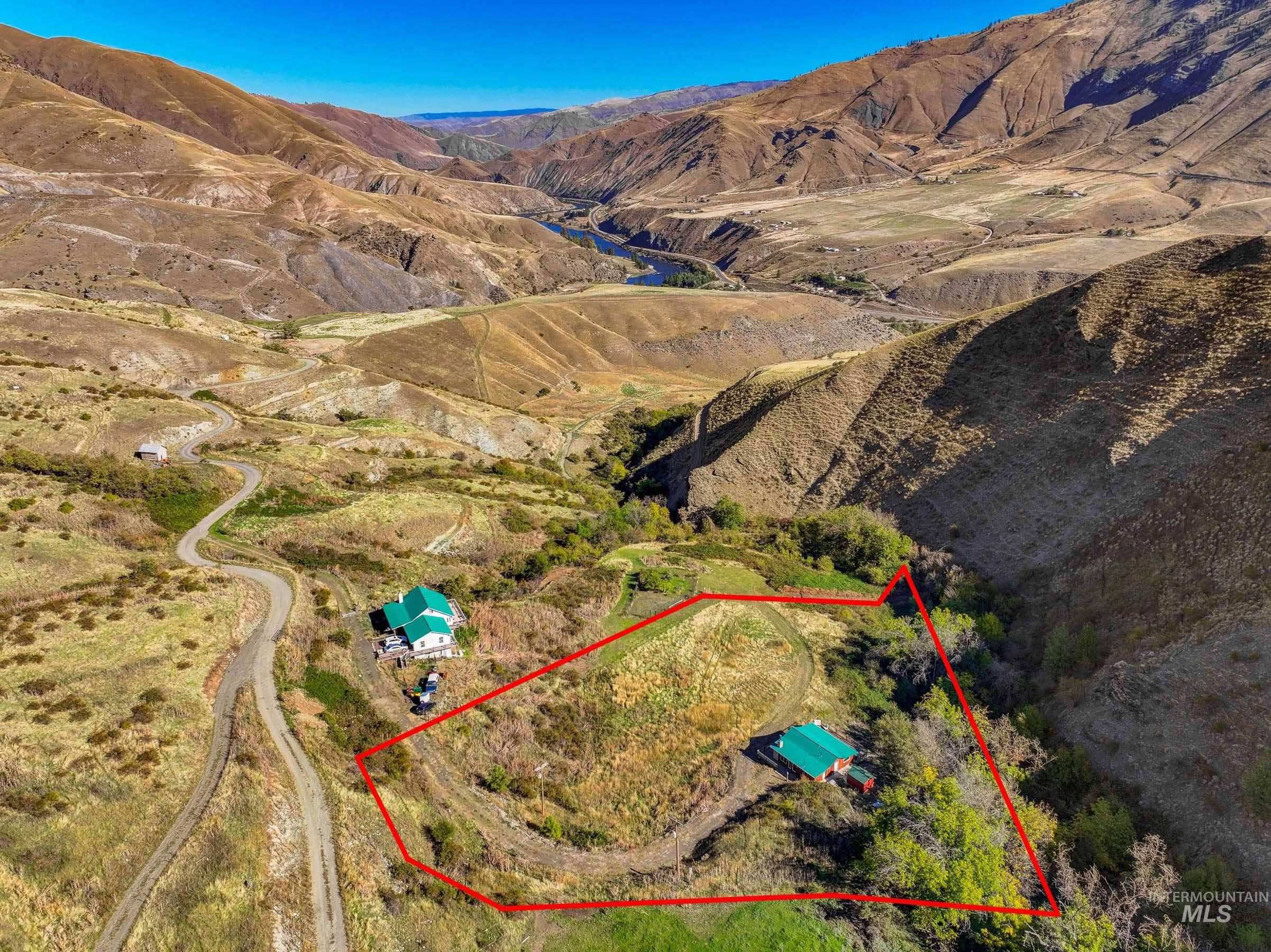 Aerial overview of property's location featuring property parcel outlined and a mountainous background