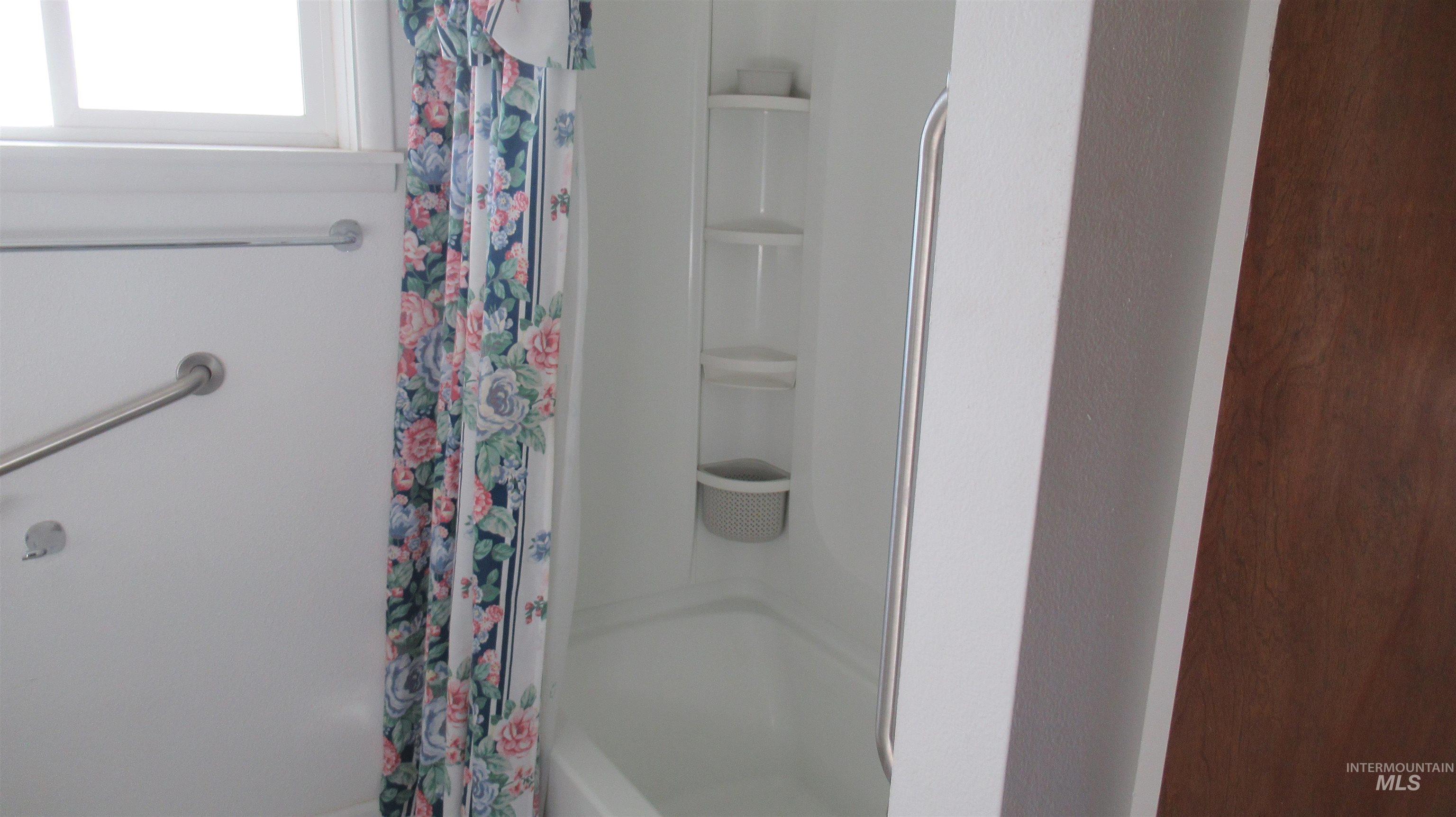 Full bathroom featuring shower / bathtub combination with curtain