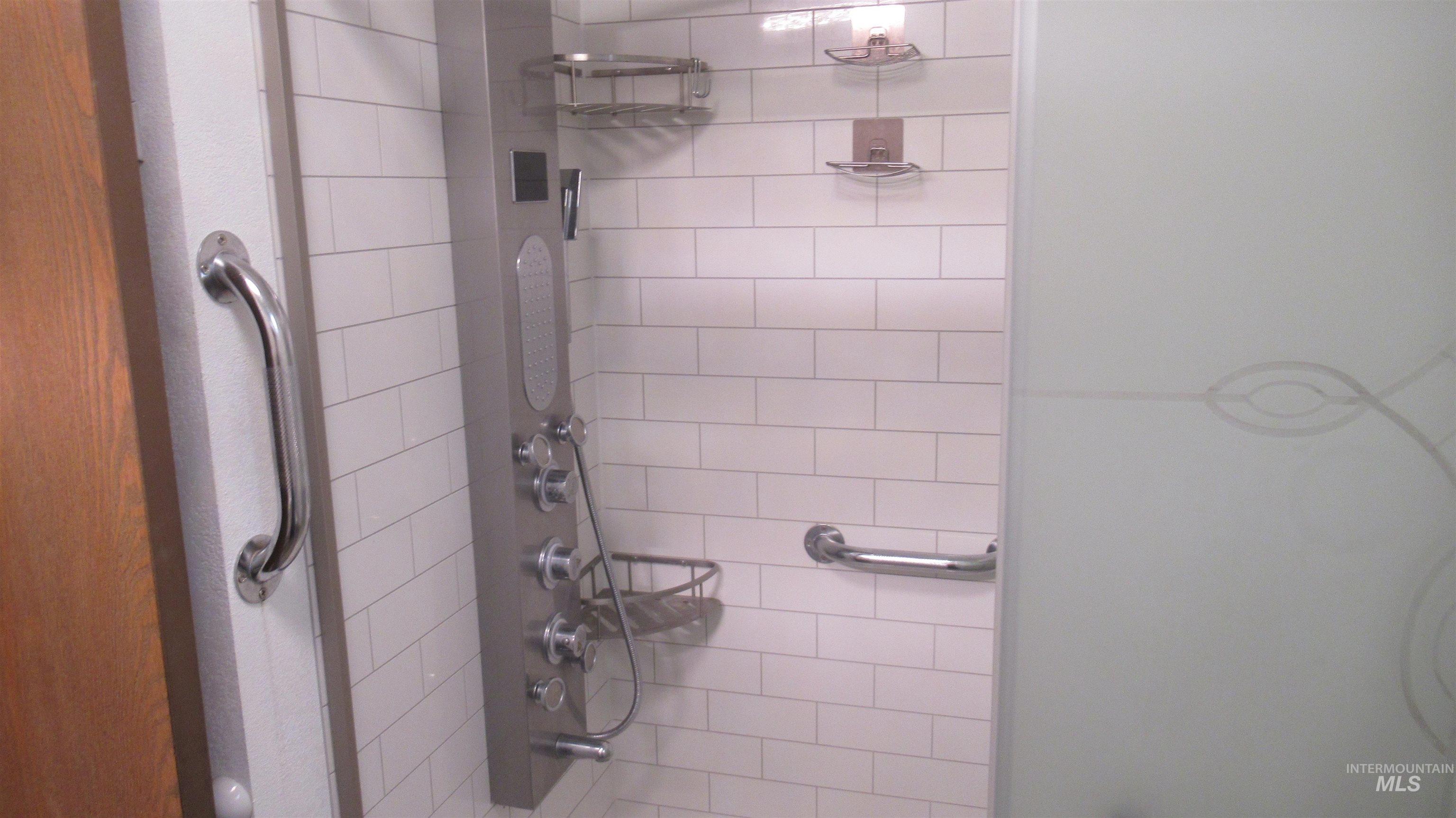 Bathroom with bath / shower combo with glass door