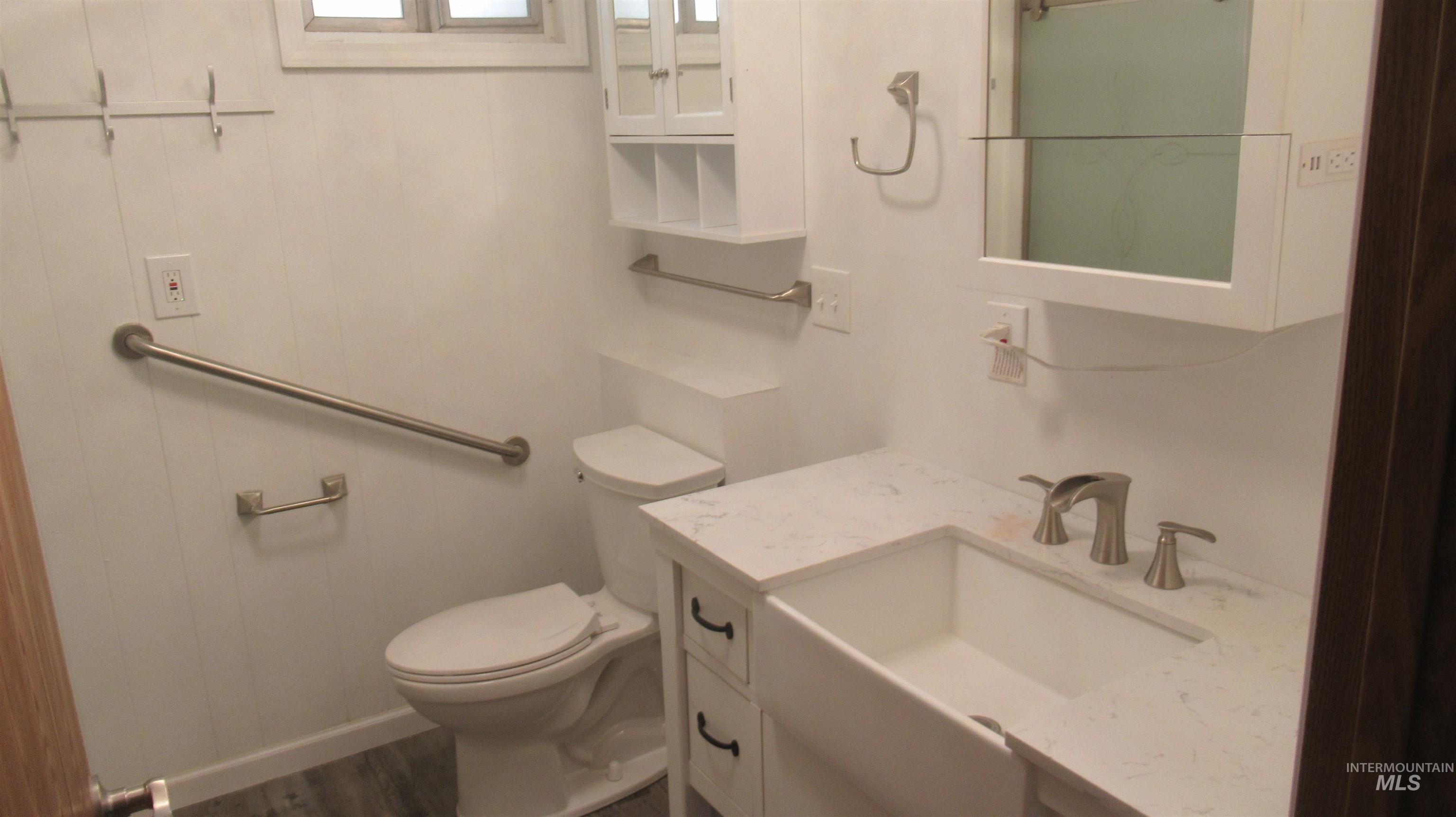 Bathroom with vanity and dark wood-type flooring