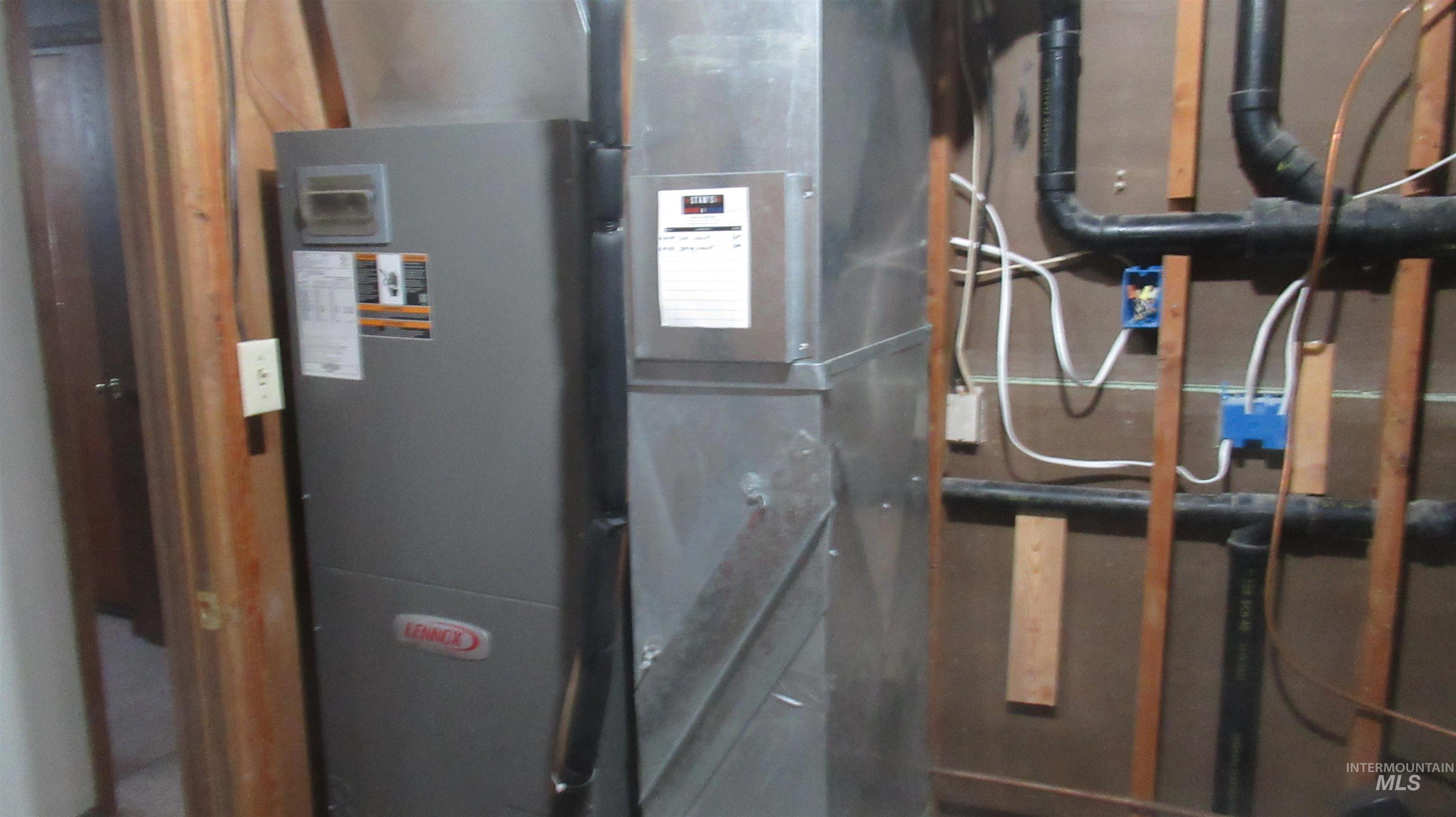 Utility room featuring heating unit