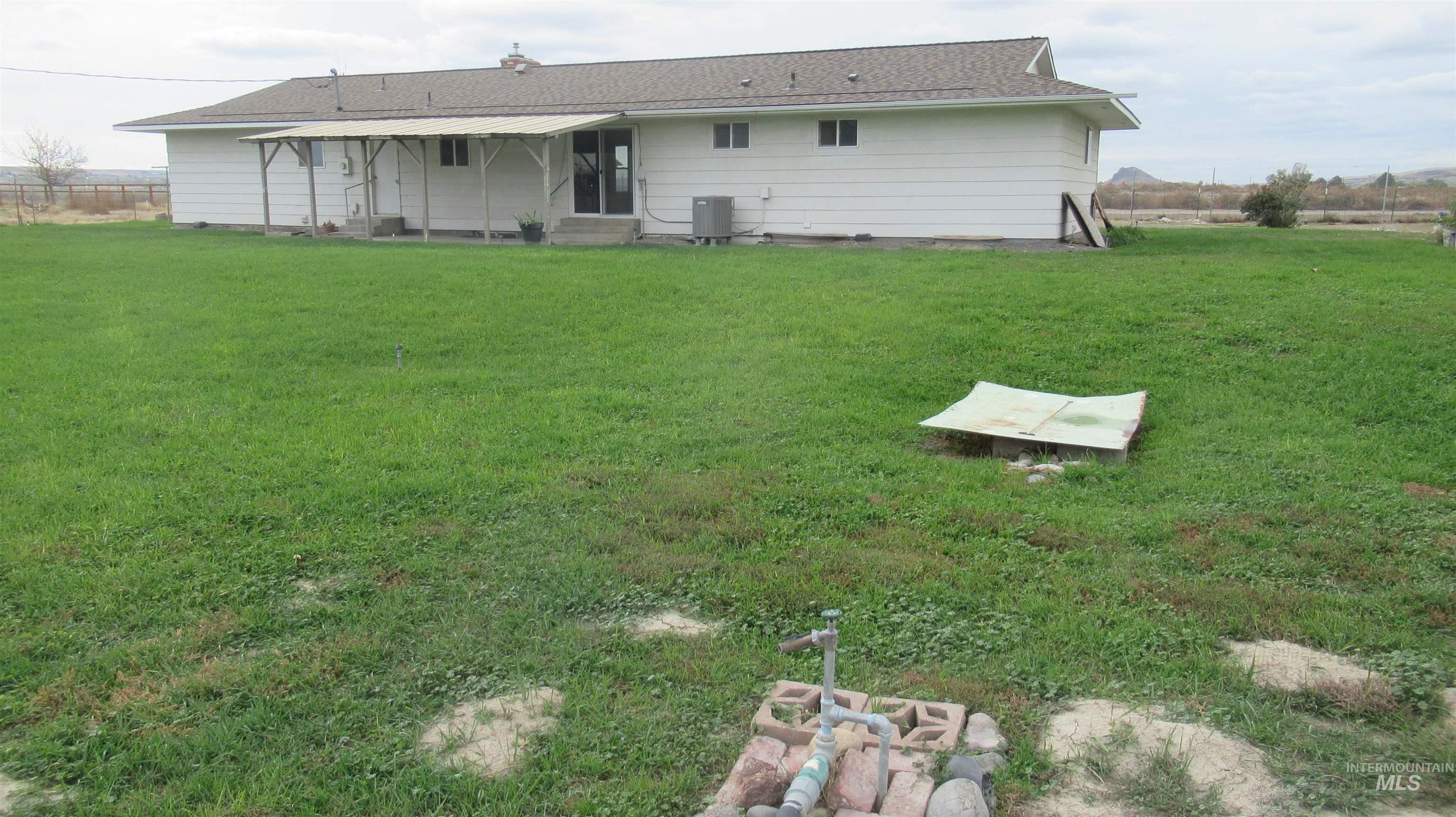 Back of property featuring a yard and entry steps