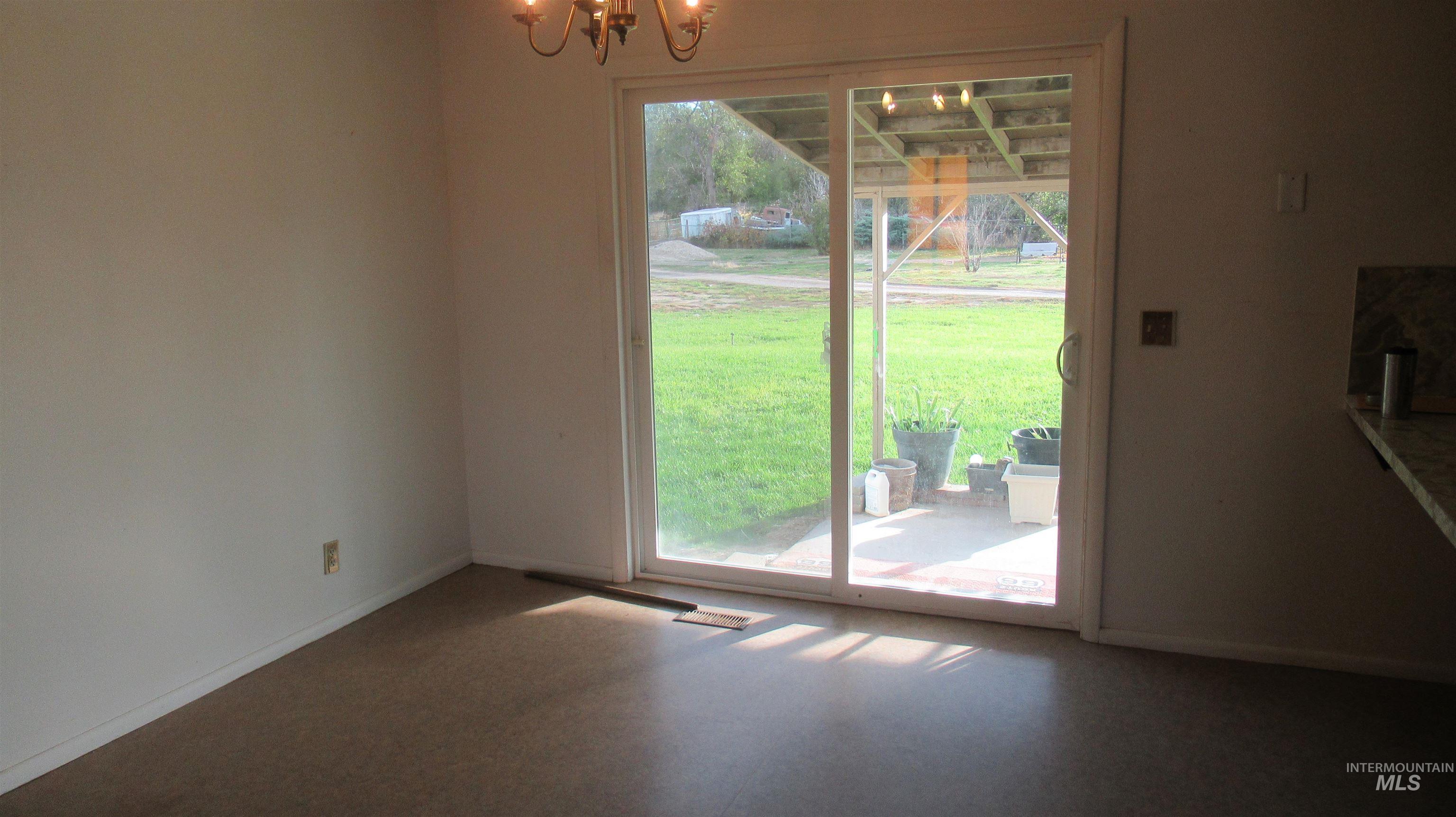 Unfurnished dining area with baseboards and a chandelier
