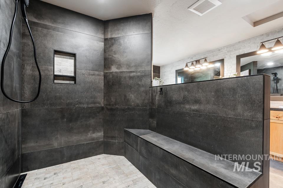 Full bathroom featuring walk in shower and vanity