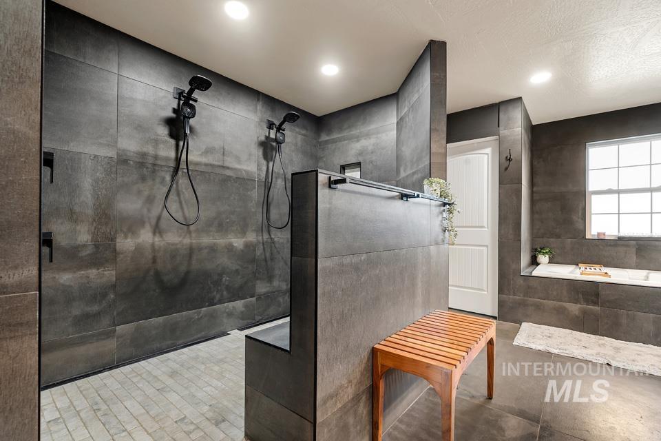 Full bathroom featuring a walk in shower and tiled tub