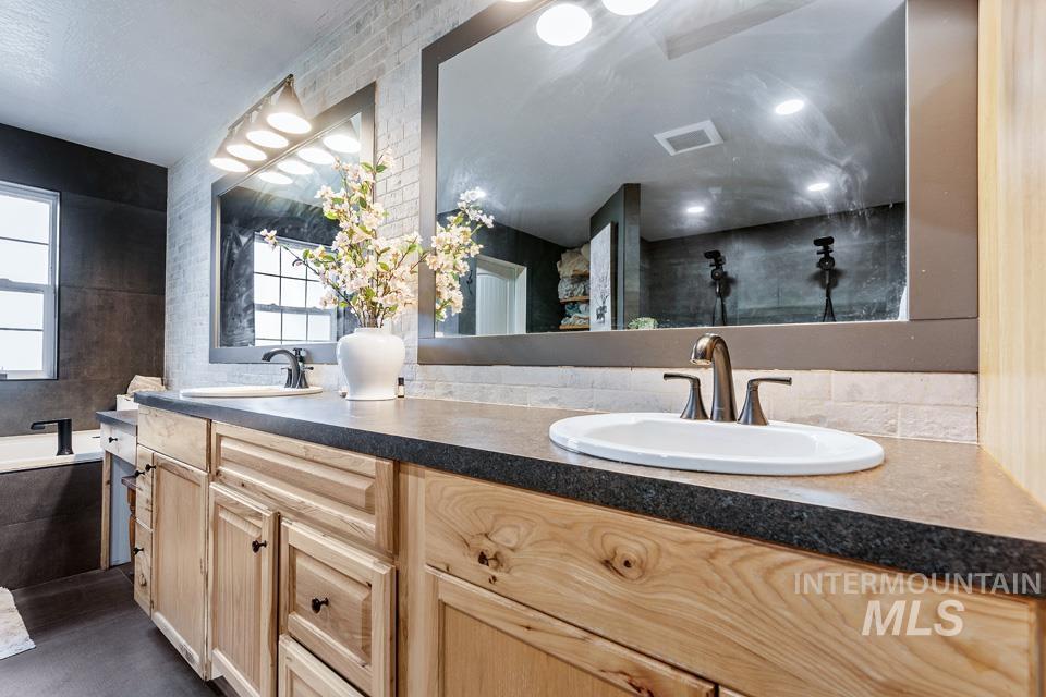 Bathroom with double vanity and a bath