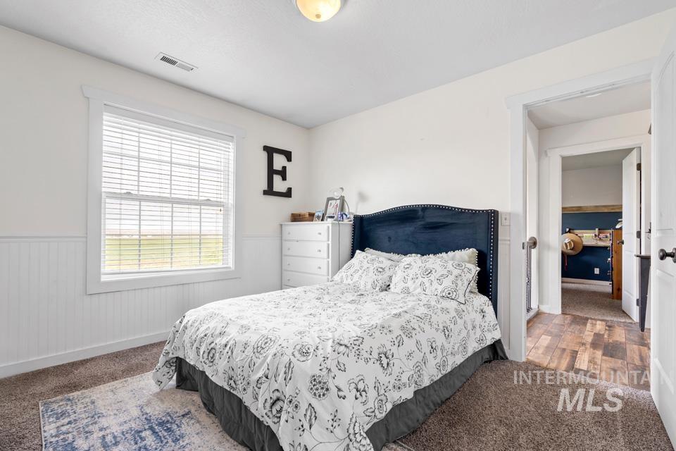 Carpeted bedroom with wainscoting